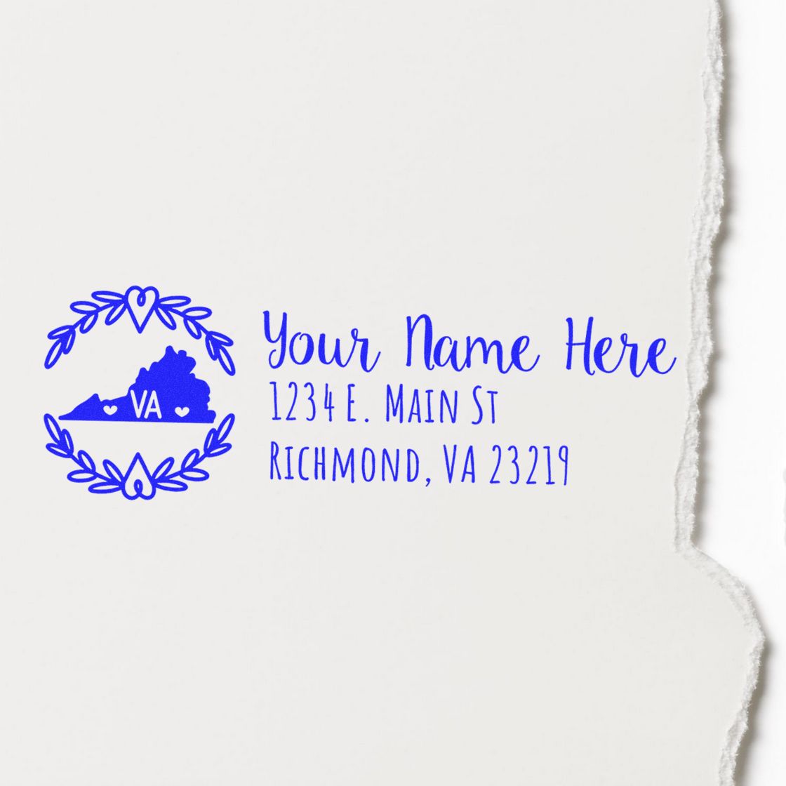 Image of a Virginia State Custom Return Address Stamp featuring a blue outline of Virginia with VA inside, surrounded by a floral design, and sample address text on a light background.