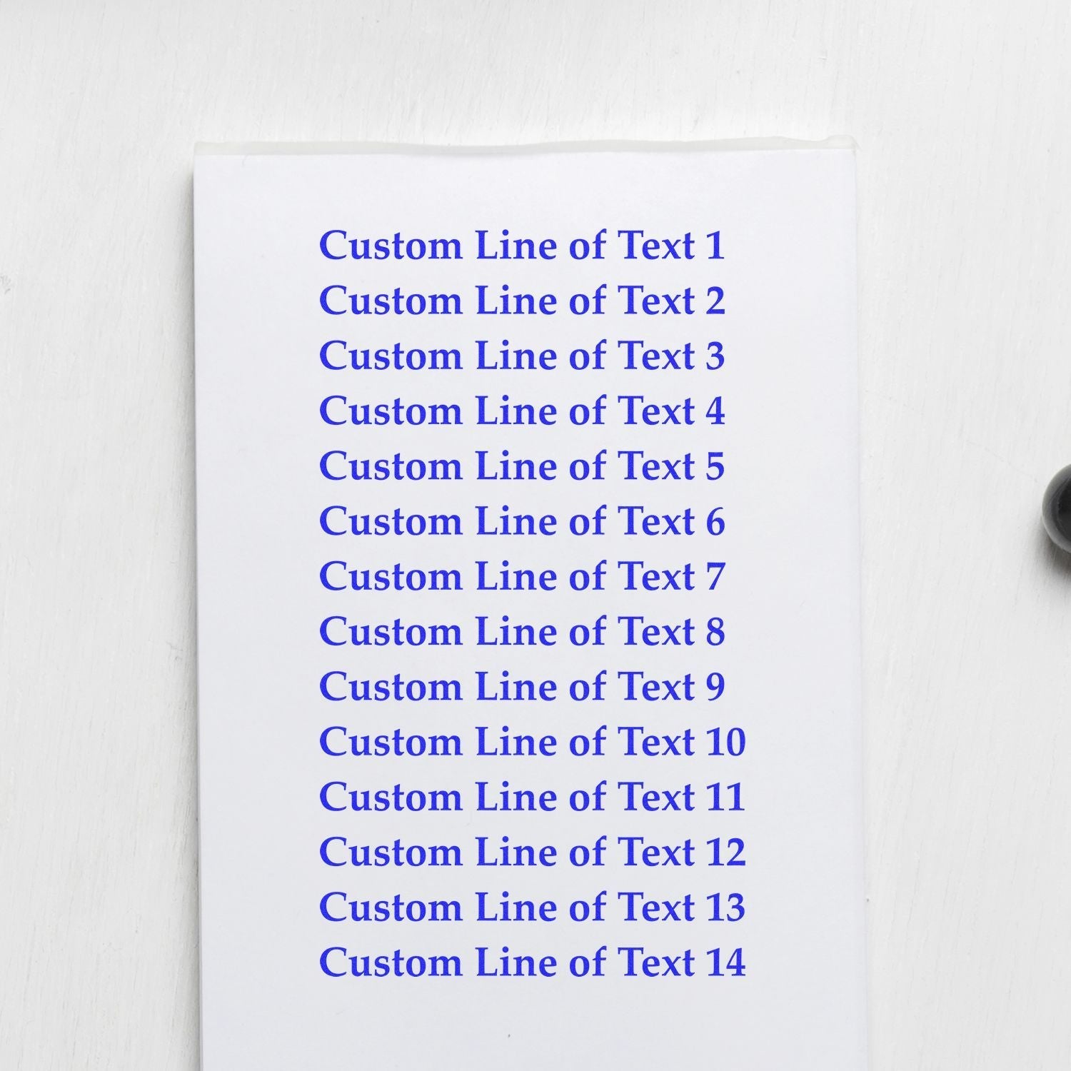 14 Line Custom Rubber Stamp with Wood Handle in use, showing 14 lines of blue text on white paper.