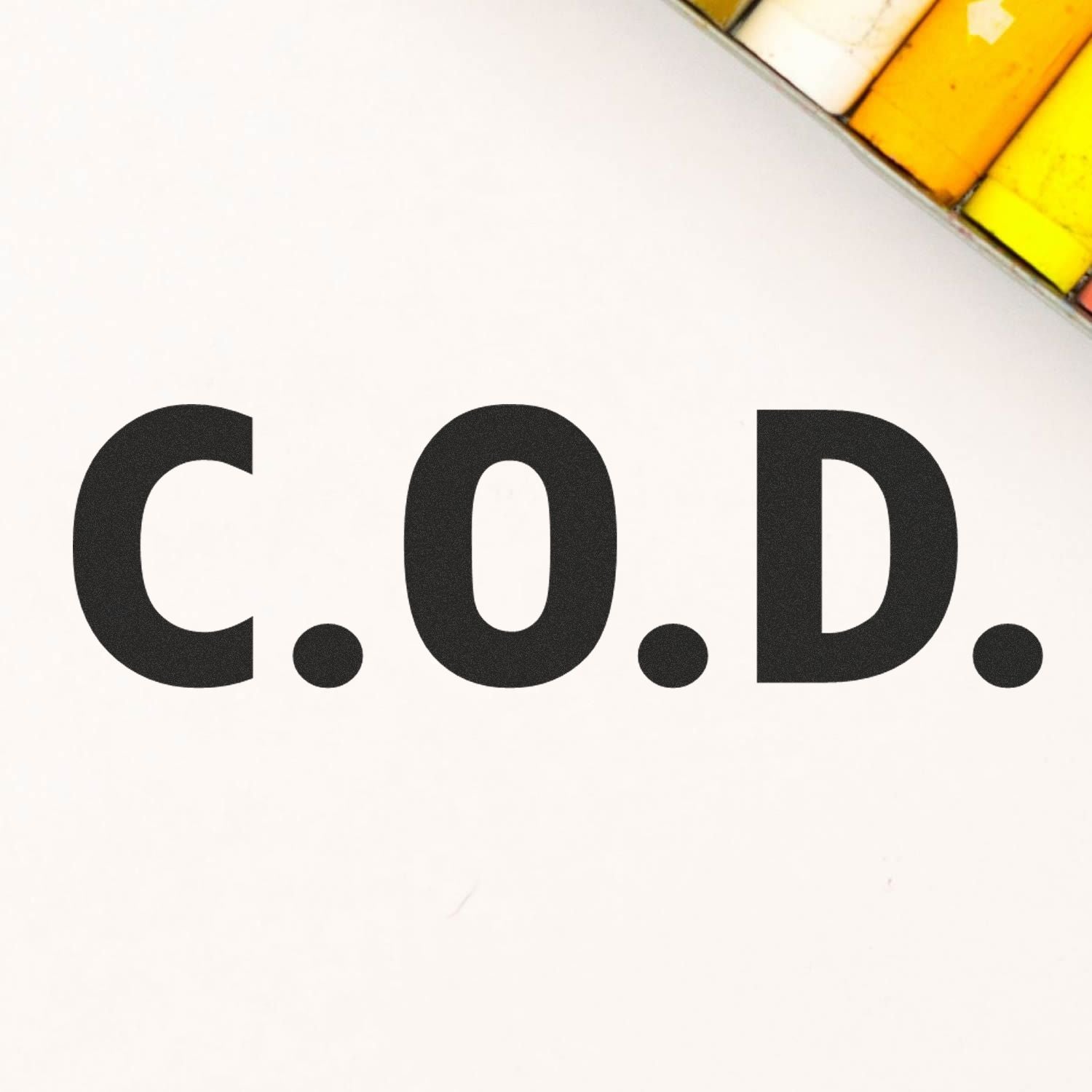 Large Pre-Inked C.O.D. Stamp with bold black letters C.O.D. on a white background, partially showing a yellow and white object.