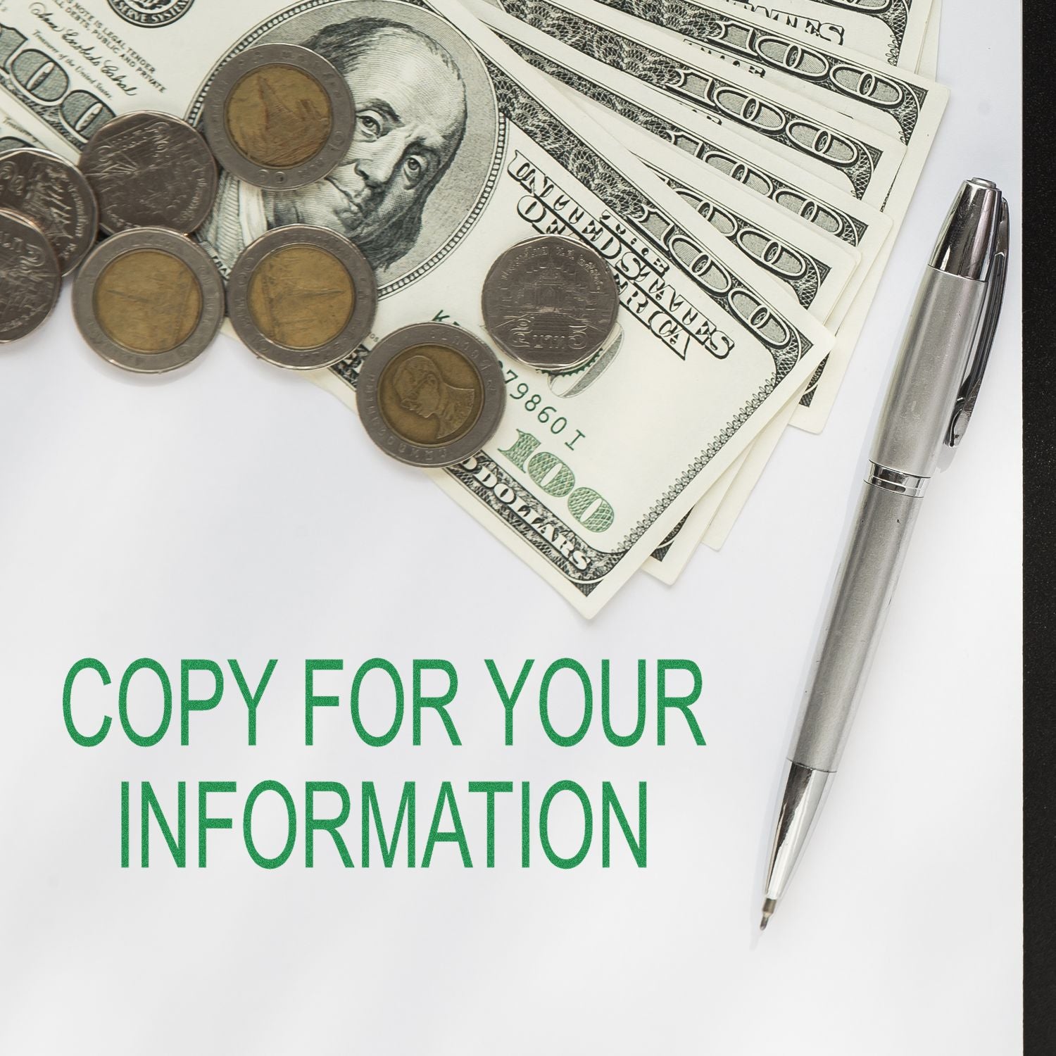 Large Pre-Inked Copy For Your Information Stamp on paper with a pen, coins, and dollar bills in the background.