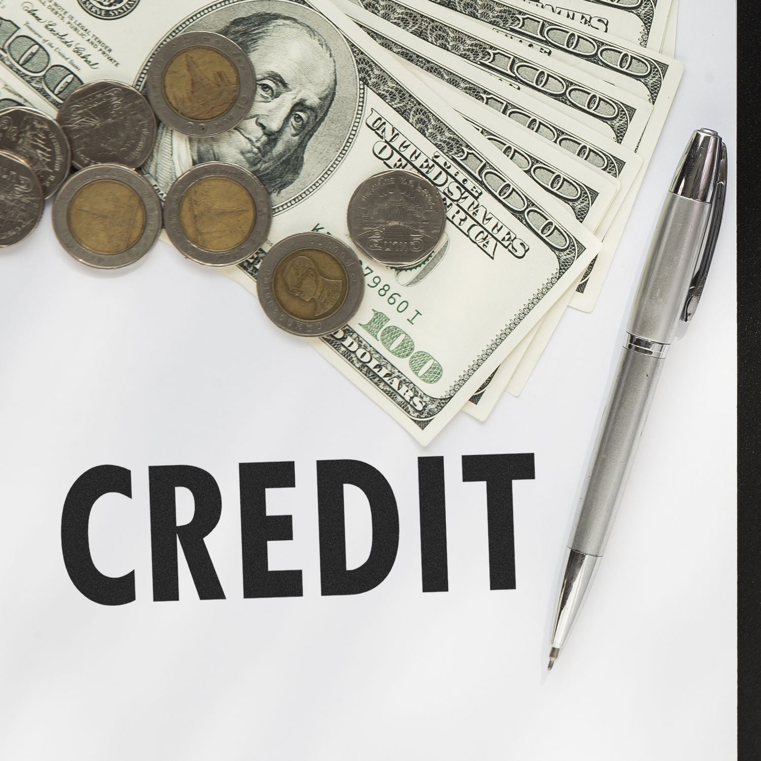 Large Pre-Inked Credit Stamp next to a stack of dollar bills, coins, and a pen on a white surface with the word CREDIT in bold black letters.