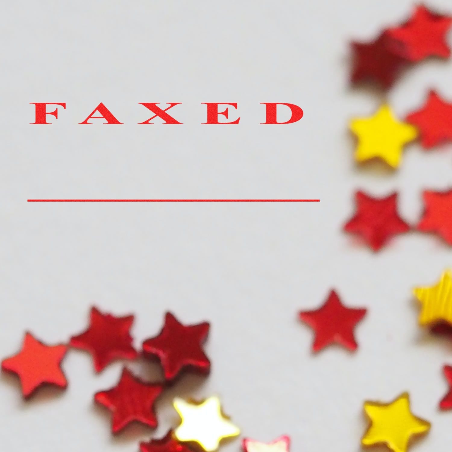 Image of a Large Pre-Inked Faxed Stamp Two Lines with red FAXED text and red and yellow star confetti on a white background.