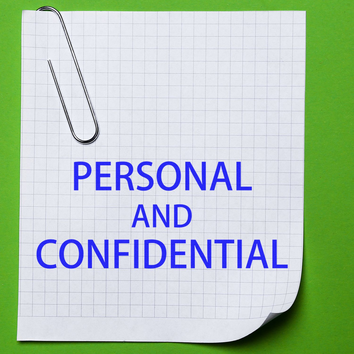 A Large Pre-Inked Personal Confidential Stamp on a green background with a paperclip and a grid paper labeled PERSONAL AND CONFIDENTIAL.