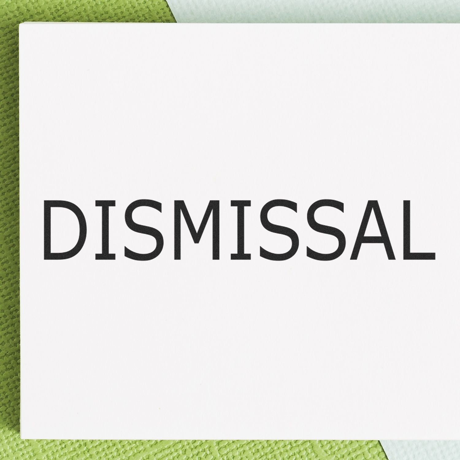 Large Pre-Inked Dismissal Stamp with bold black DISMISSAL text on a white background, placed on a green textured surface.