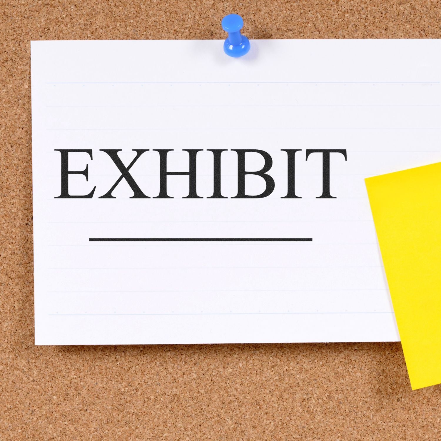 Large Pre-Inked Exhibit Stamp on a corkboard with a blue pushpin and a yellow sticky note.