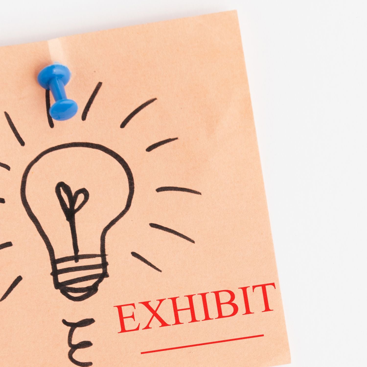 A sticky note with a lightbulb drawing and the word EXHIBIT stamped in red using a Large Pre-Inked Exhibit Stamp, pinned with a blue pushpin.