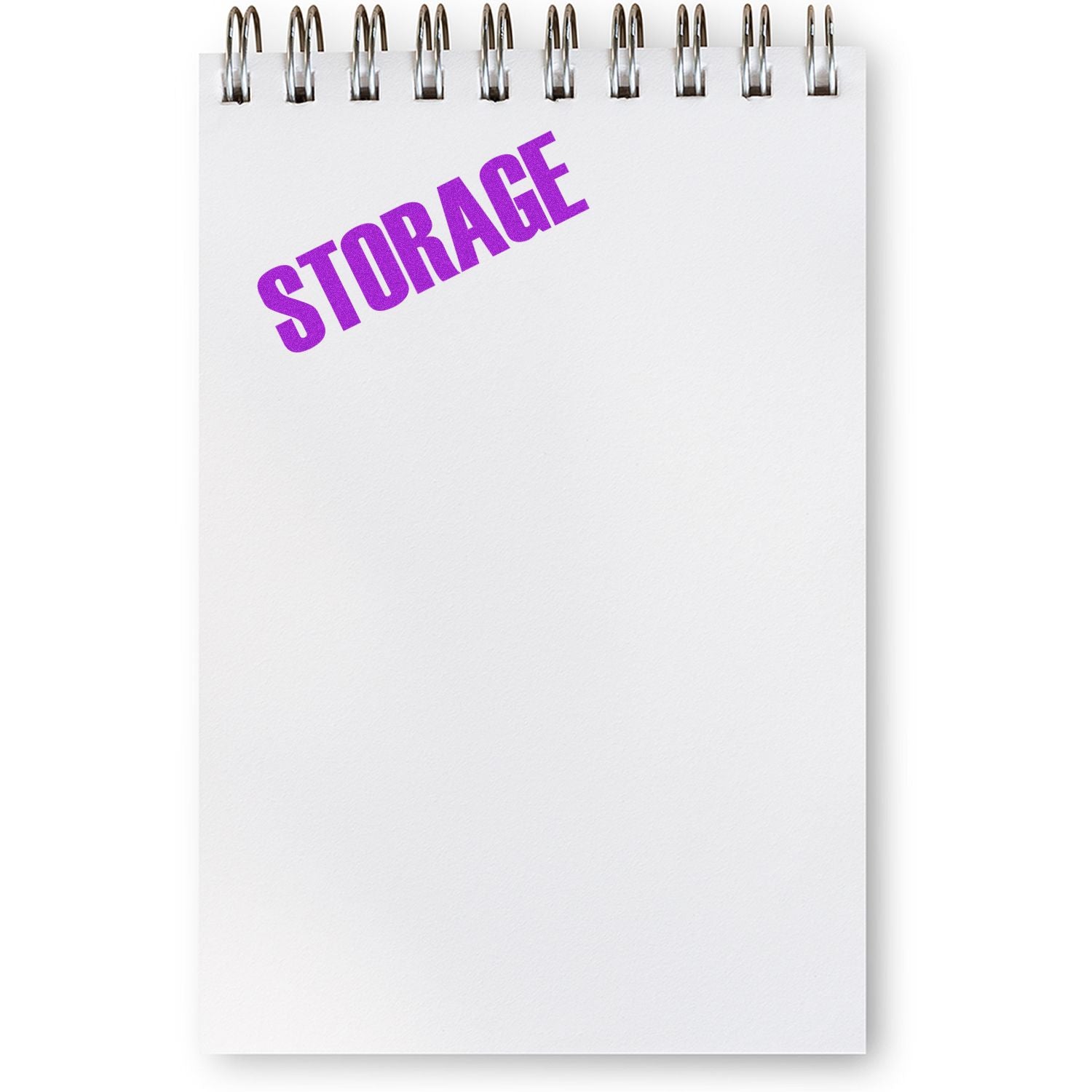 A white notepad with a spiral binding featuring a purple STORAGE imprint from the Large Pre-Inked Storage Stamp.