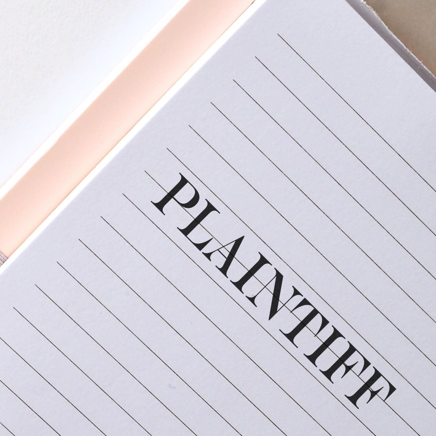 Large Pre-Inked Plaintiff Stamp imprint on a lined notebook page, showcasing clear and bold text.