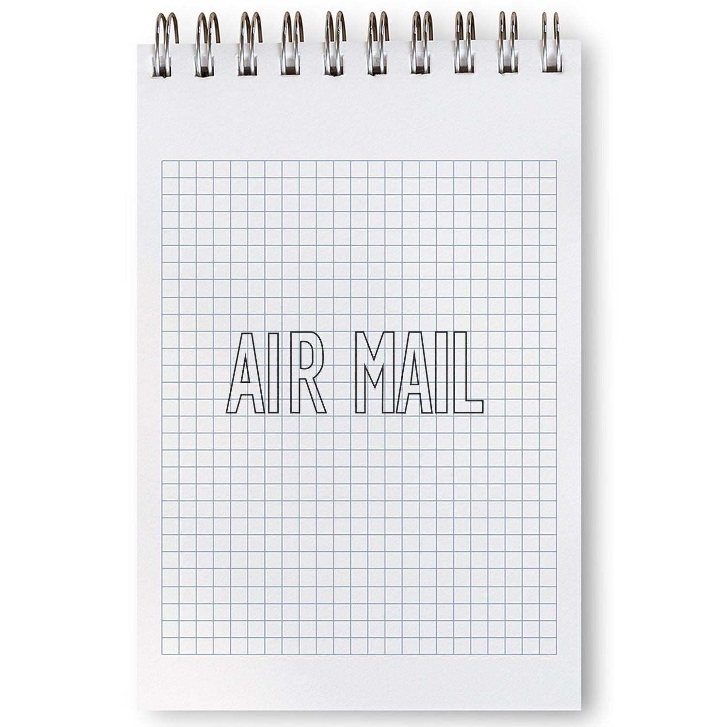 A notebook with a grid pattern and the words AIR MAIL stamped on it using the Large Pre-Inked Outline Air Mail Stamp.