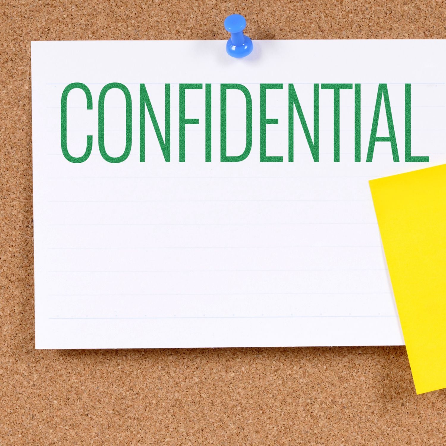 A corkboard with a white paper stamped CONFIDENTIAL using the Large Pre-Inked Narrow Font Confidential Stamp, pinned with a blue pushpin.