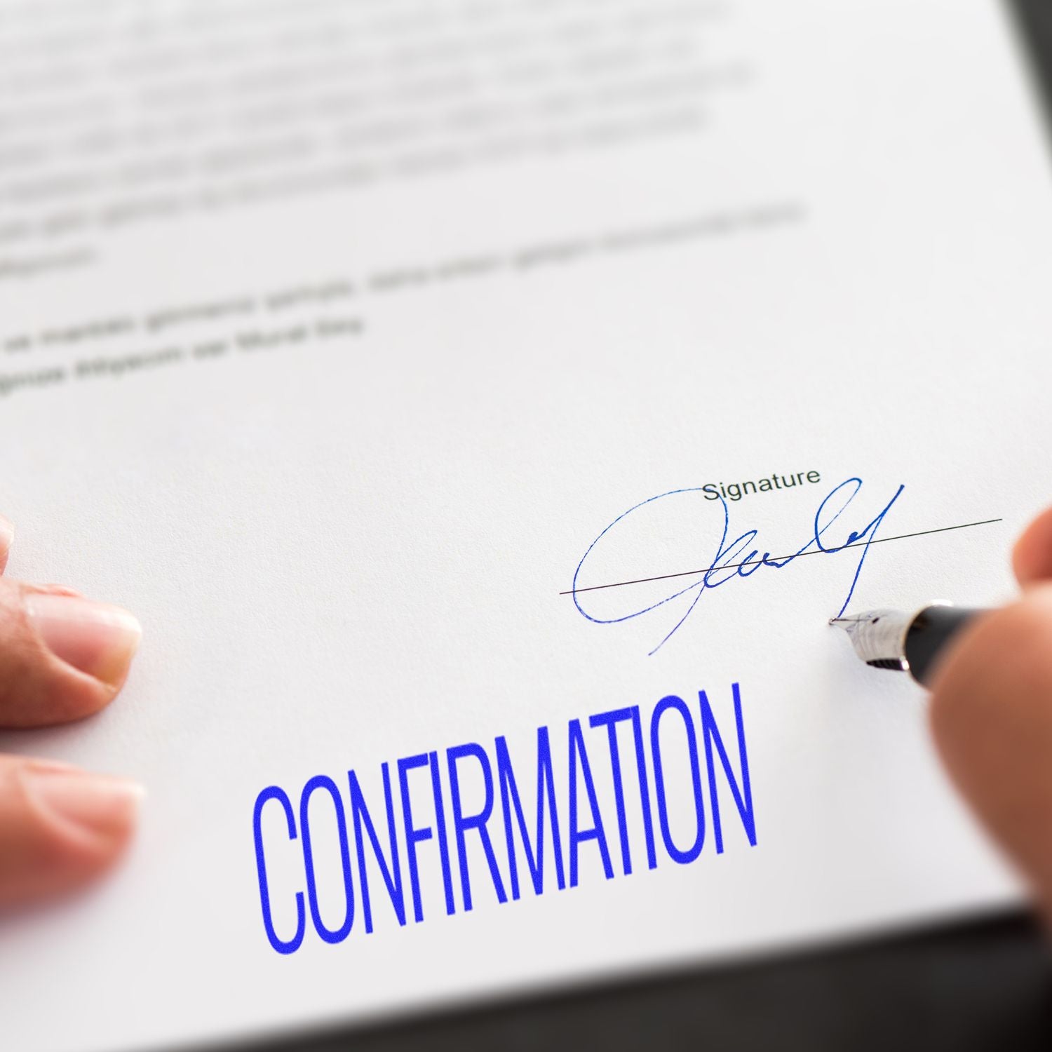 Person using a Large Pre-Inked Confirmation Stamp on a document, with the word CONFIRMATION in blue ink and a signature above it.