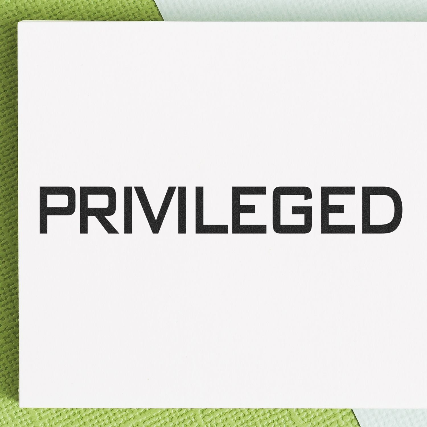 Large Pre-Inked Privileged Stamp with bold black text PRIVILEGED on a white background, placed on a green textured surface.