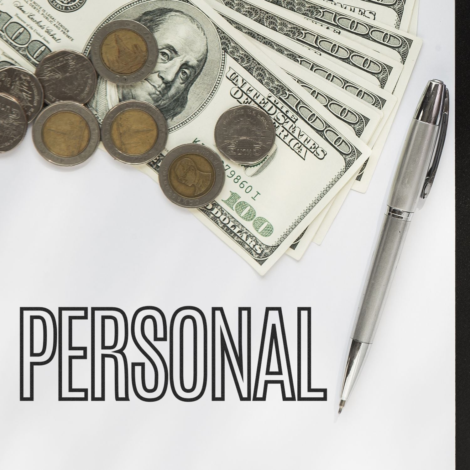 Large Pre-Inked Outline Personal Stamp next to a pen, coins, and dollar bills on a white surface with the word PERSONAL printed.