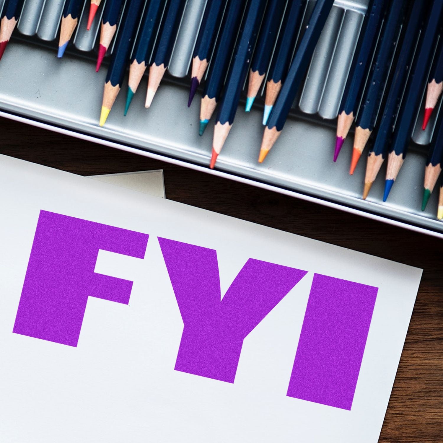 Large Pre-Inked Bold FYI Stamp in purple ink on paper, with colored pencils in the background.