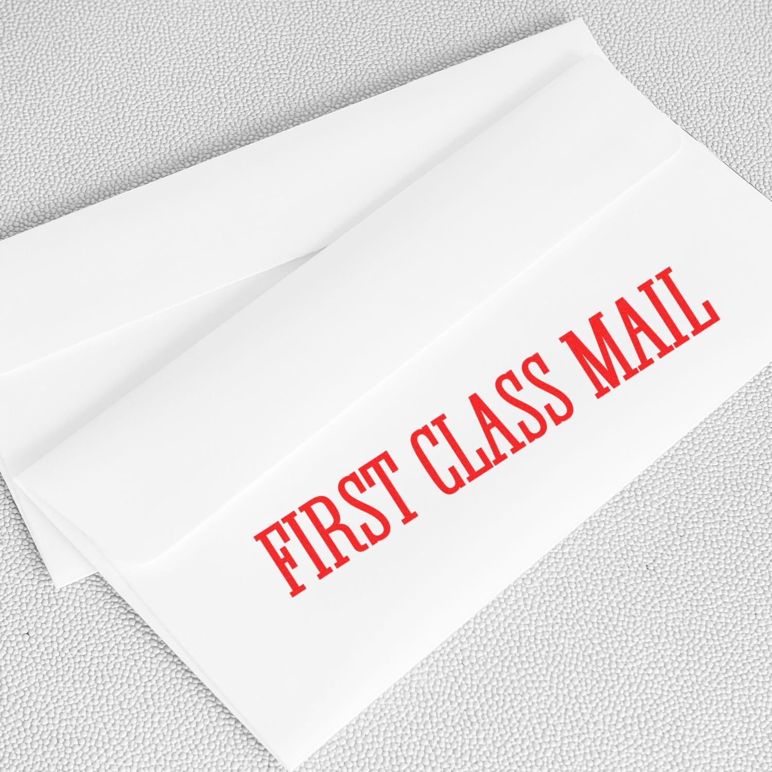 Large Pre-Inked Times First Class Mail Stamp in red ink on a white envelope, emphasizing the First Class Mail text.