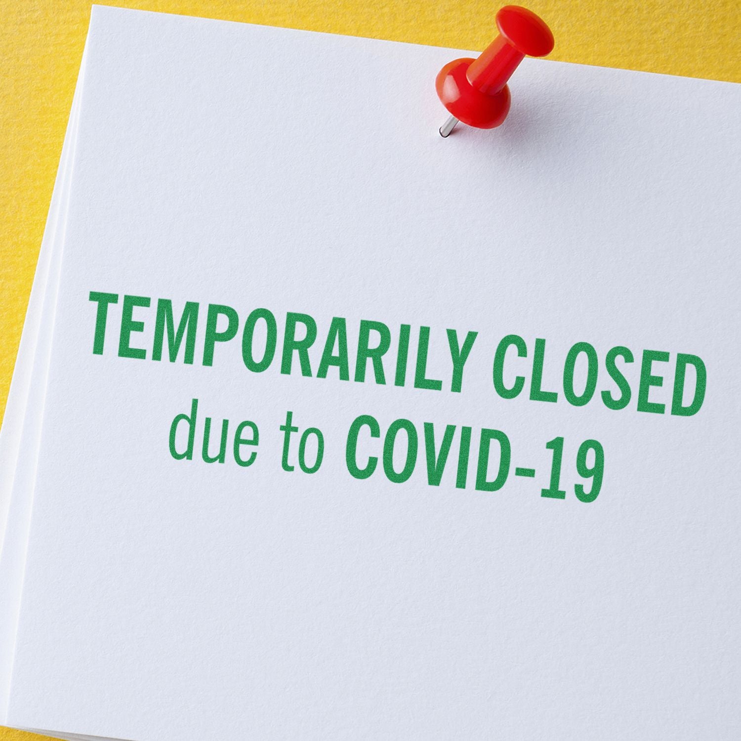 A white paper stamped with Temporarily Closed due to COVID-19 using a Large Self Inking Temporarily Closed Stamp, pinned with a red pushpin.