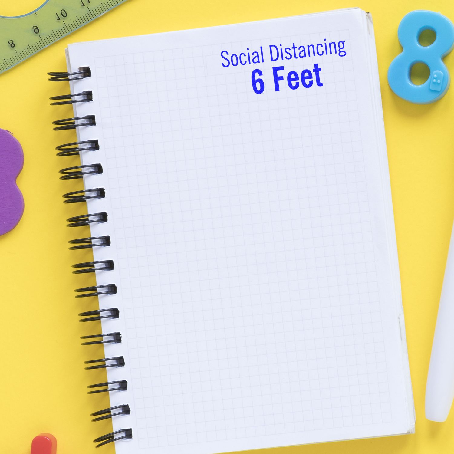 Large Social Distancing 6 Feet Self-Inking Stamp on a yellow background with a notebook, ruler, and colorful stationery items.