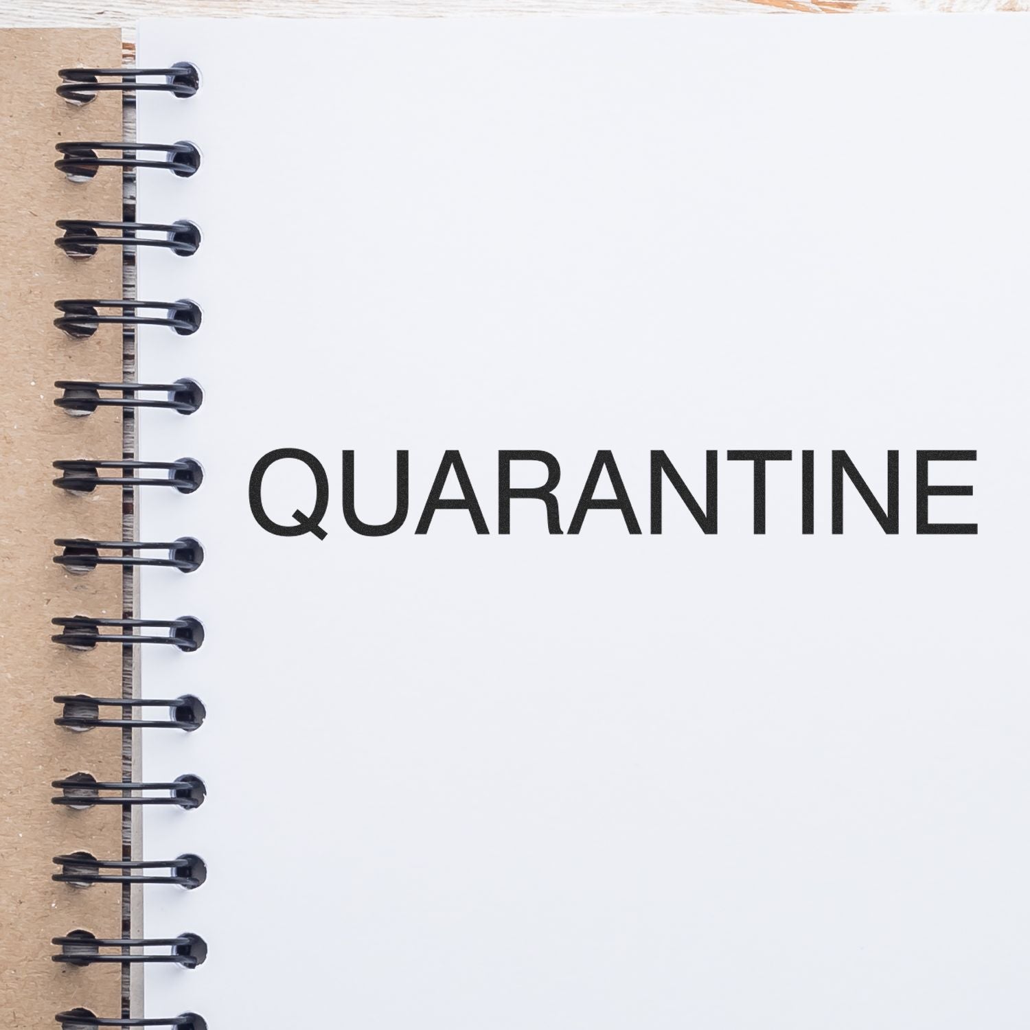 Large Self Inking Quarantine Stamp imprint on a white page of a spiral notebook, showcasing clear and bold black text.