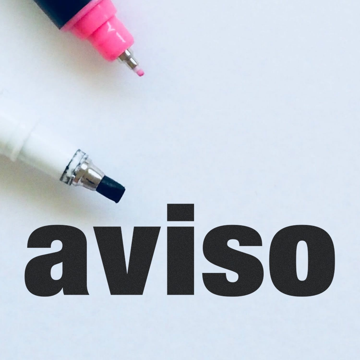 Large Self Inking Aviso Stamp on a white background with pink and white markers nearby.