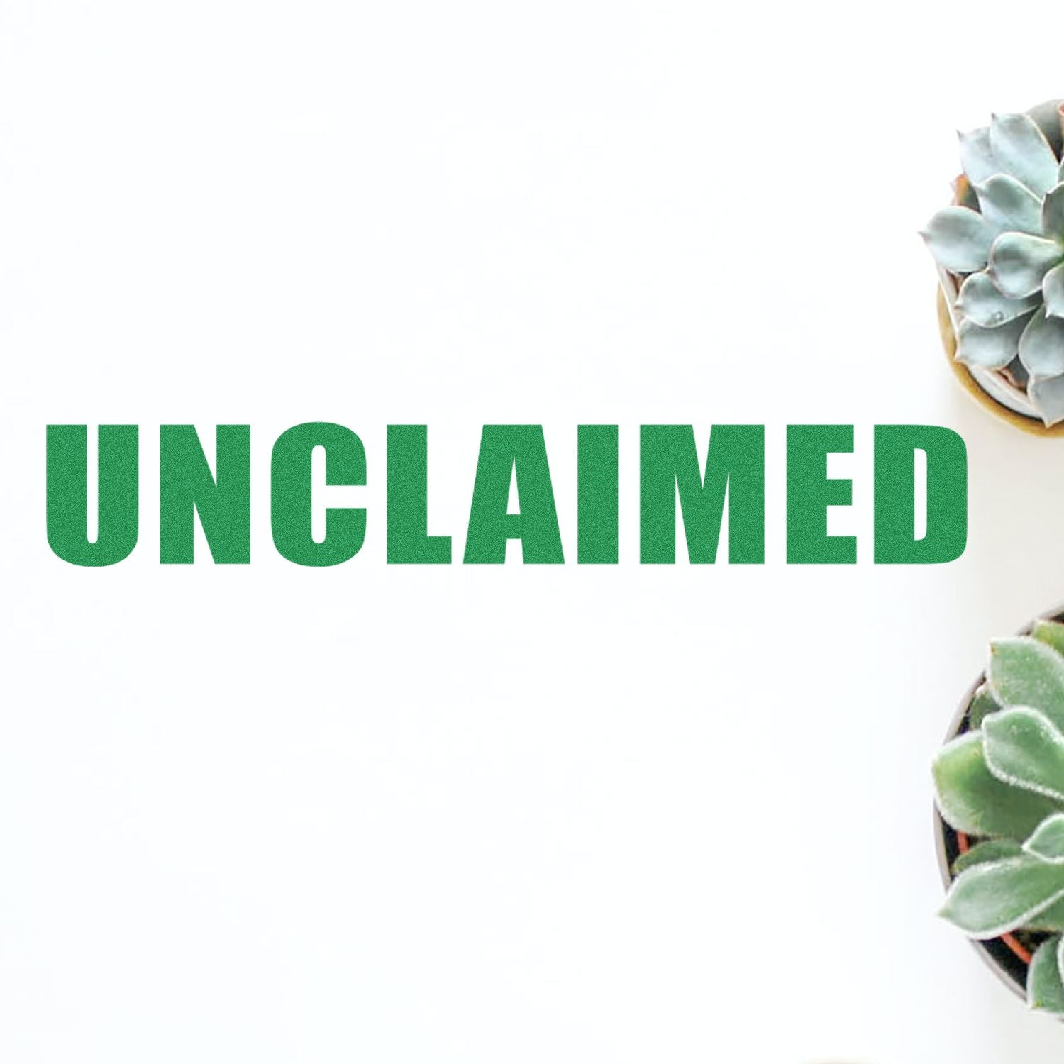 Large Pre-Inked Unclaimed Stamp in green ink on white background, surrounded by small potted succulents.