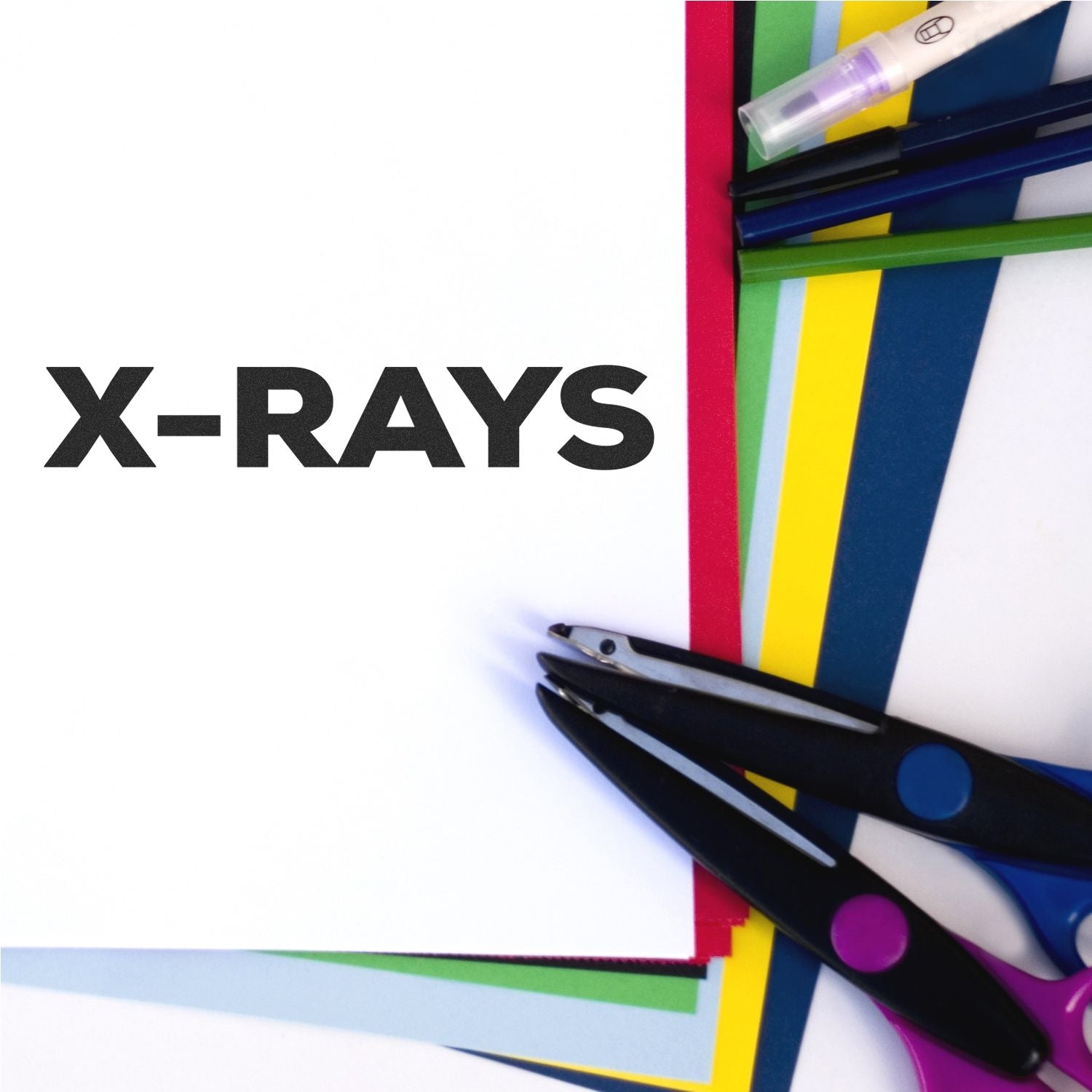 Large Pre-Inked Bold X-Rays Stamp on white paper with colorful sheets and office supplies in the background.