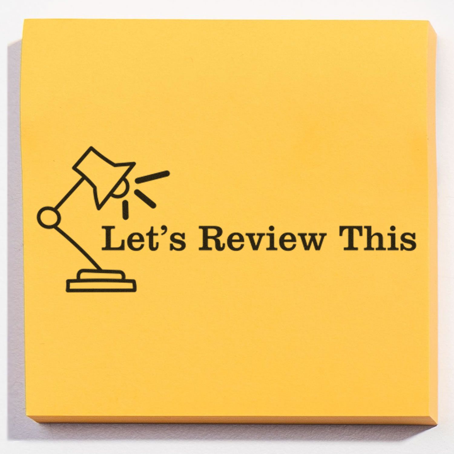 Yellow sticky note with the Large Pre-Inked Let's Review This with Lamp Stamp, featuring a lamp icon and the text Let's Review This.