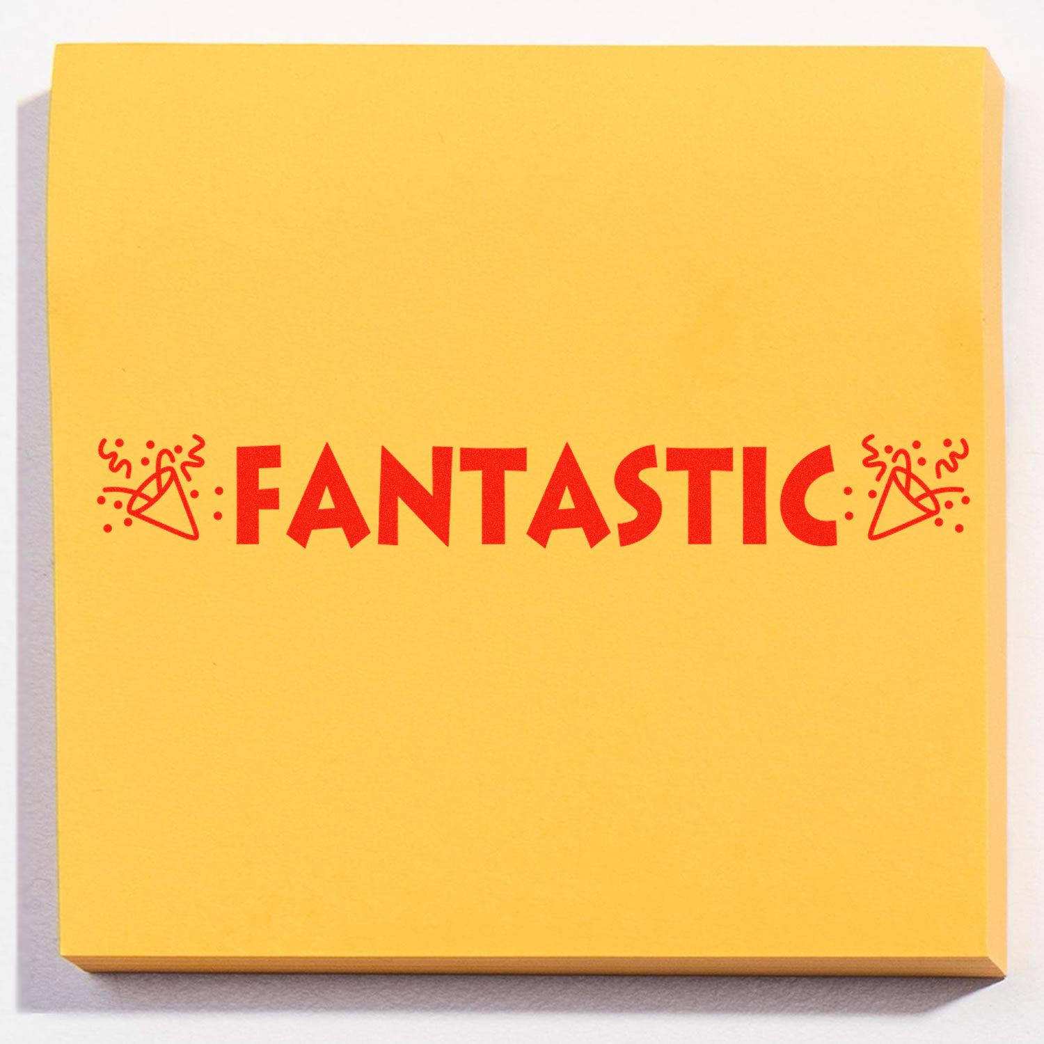 Large Pre-Inked Fantastic with Icons Stamp on a yellow sticky note, featuring the word FANTASTIC in red with celebratory icons.