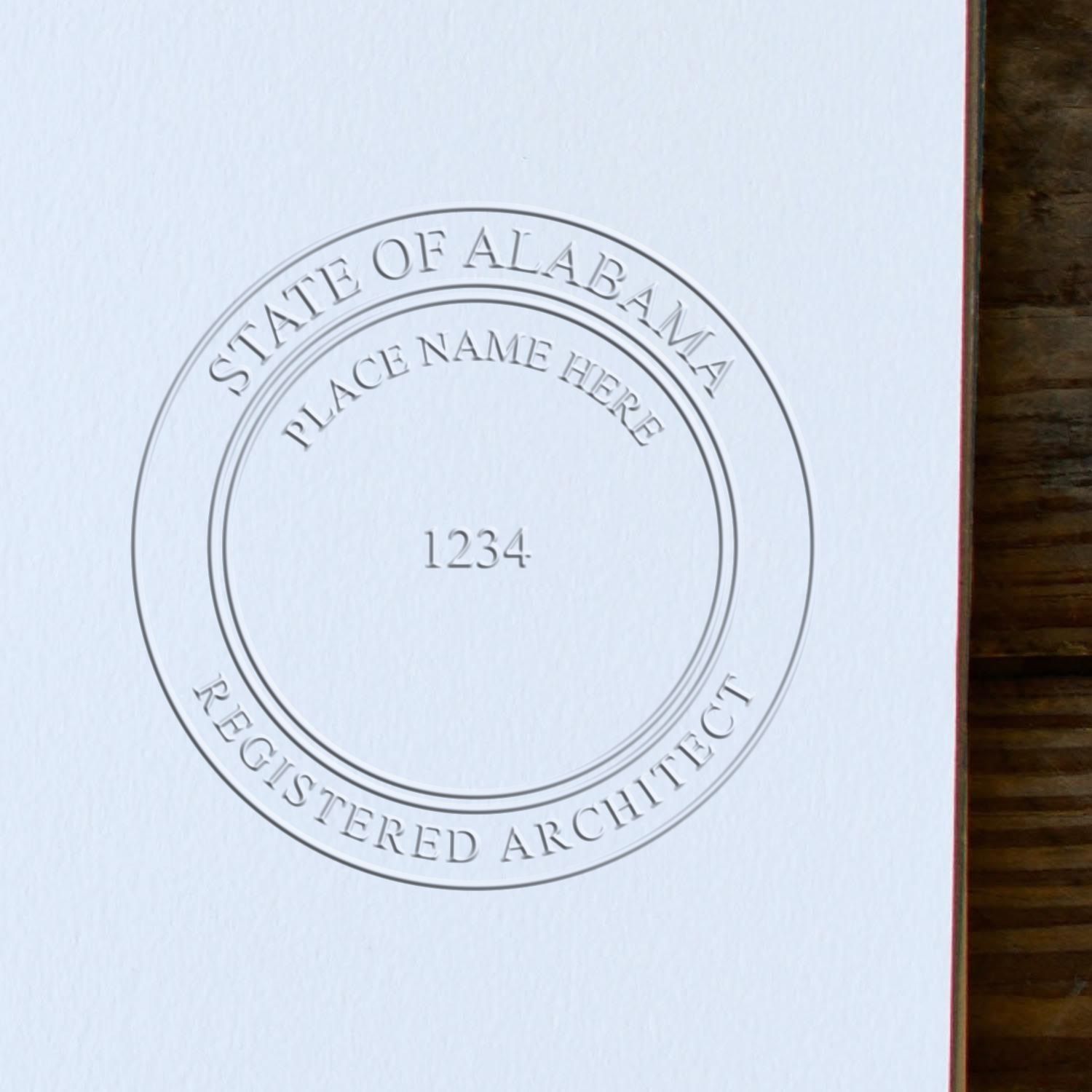 A stamped impression of the Handheld Alabama Architect Seal Embosser in this stylish lifestyle photo, setting the tone for a unique and personalized product.