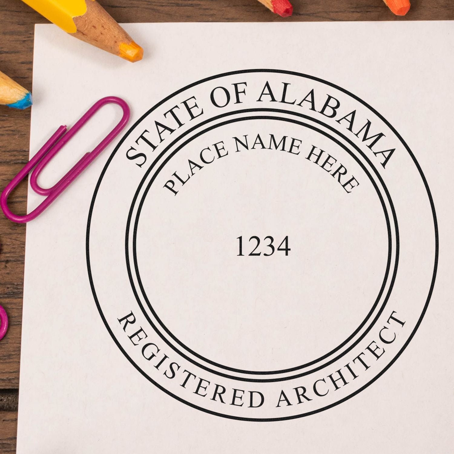 Digital Alabama Architect Stamp, Electronic Seal for Alabama Architect, displayed on a white paper with colorful paperclips and pencils.