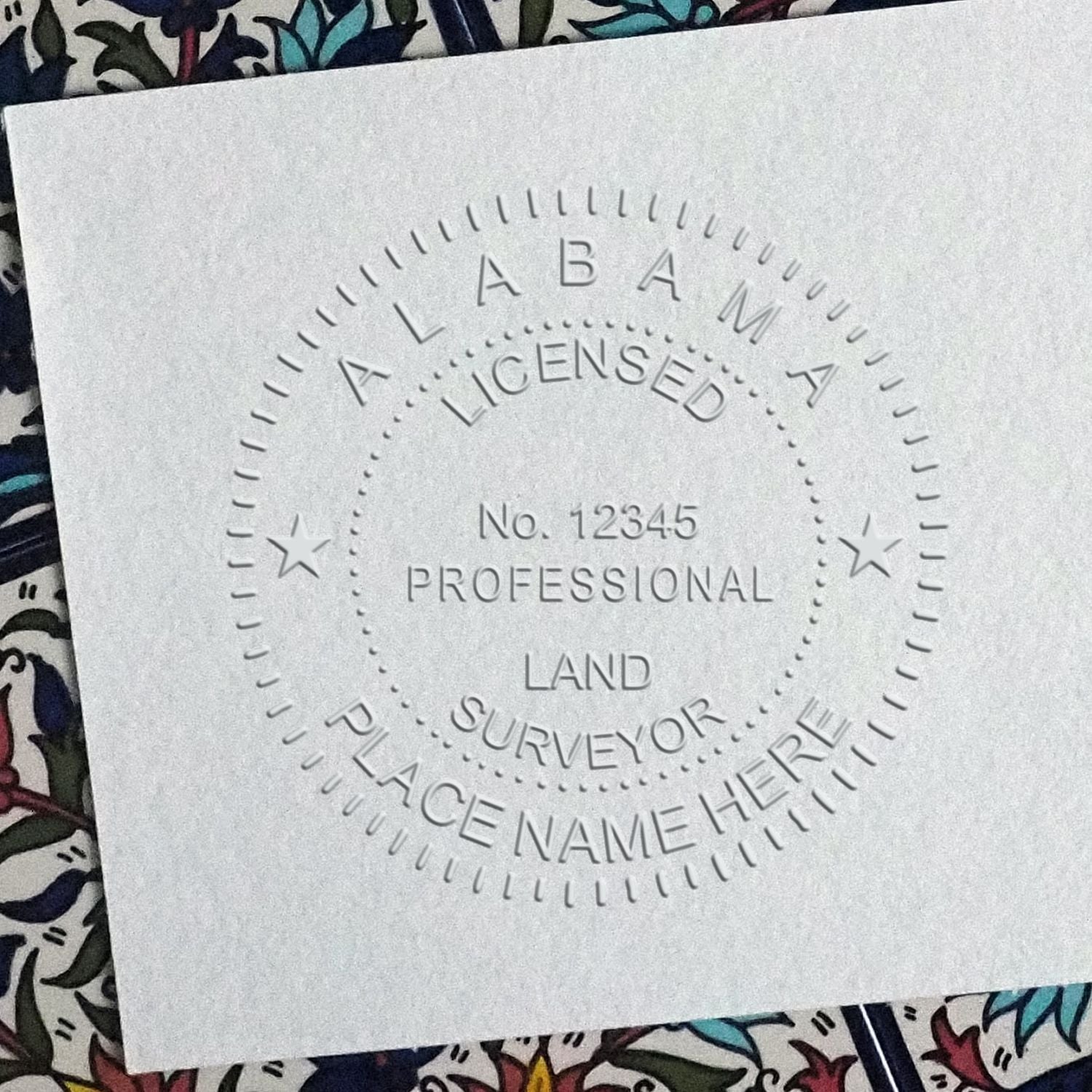 Another Example of a stamped impression of the Heavy Duty Cast Iron Alabama Land Surveyor Seal Embosser on a piece of office paper.