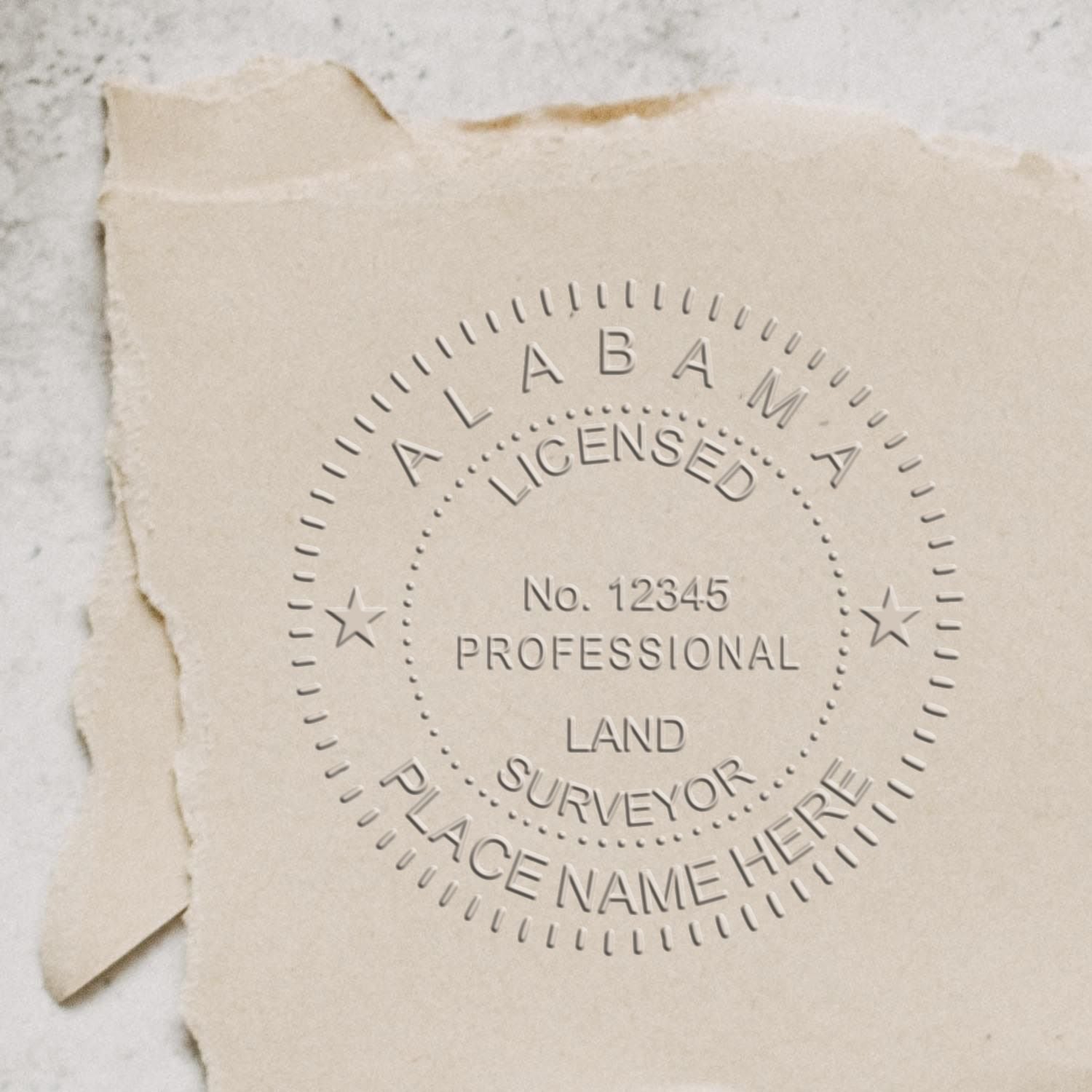 An in use photo of the Hybrid Alabama Land Surveyor Seal showing a sample imprint on a cardstock