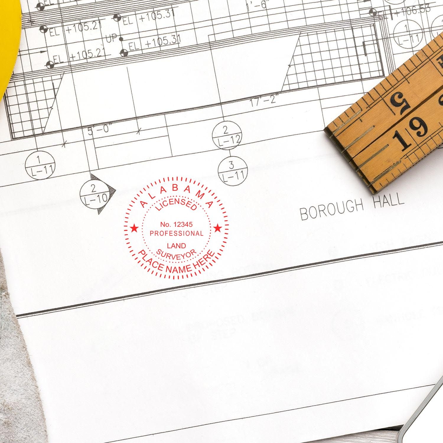 Digital Alabama Land Surveyor Stamp, Electronic Seal for Alabama Land Surveyor on a blueprint with a ruler and pencil nearby.