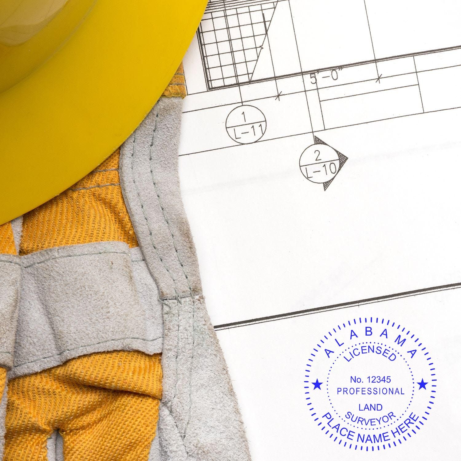 Digital Alabama Land Surveyor Stamp, Electronic Seal for Alabama Land Surveyor on a blueprint with a yellow hard hat and gloves nearby.