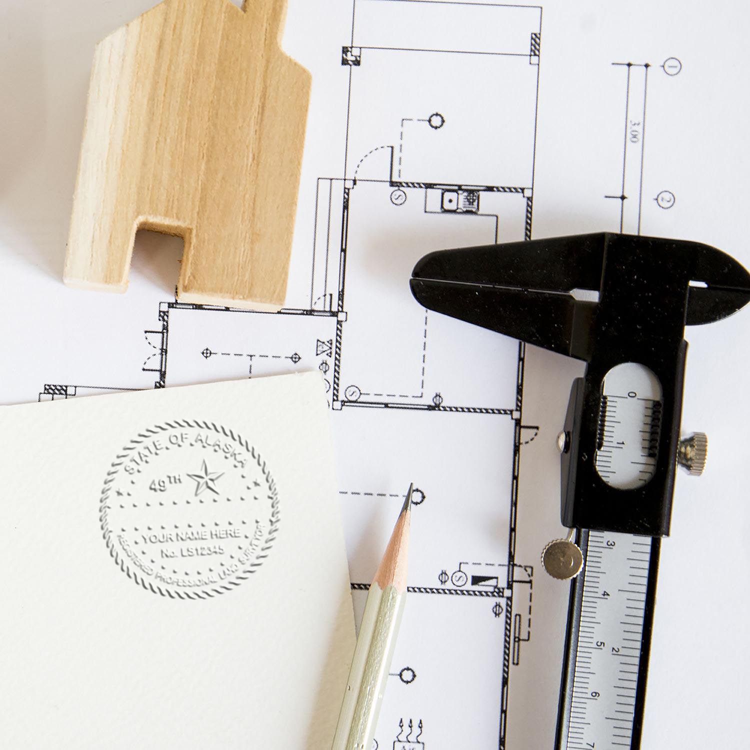 An alternative view of the Gift Alaska Land Surveyor Seal stamped on a sheet of paper showing the image in use