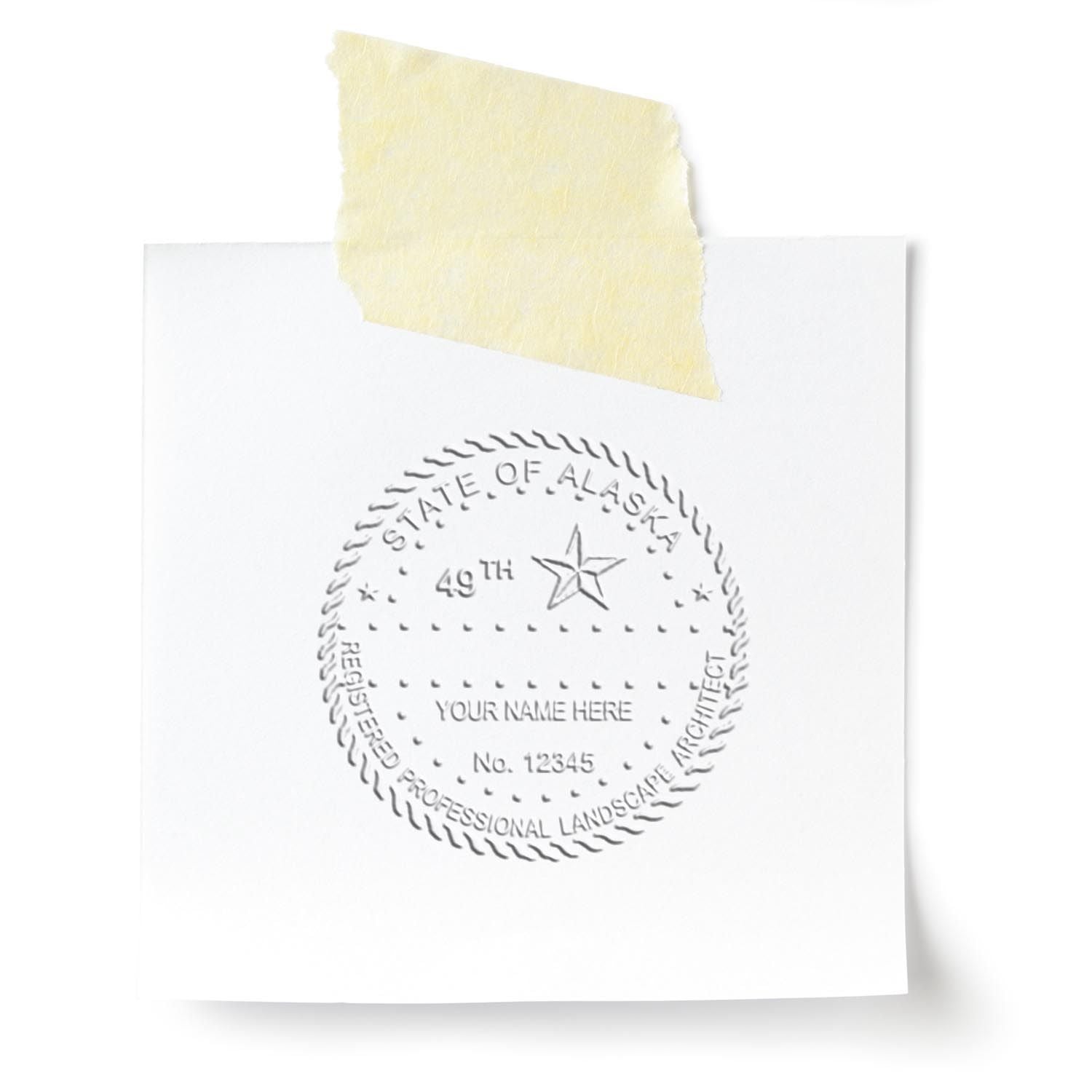 A lifestyle photo showing a stamped image of the State of Alaska Extended Long Reach Landscape Architect Seal Embosser on a piece of paper