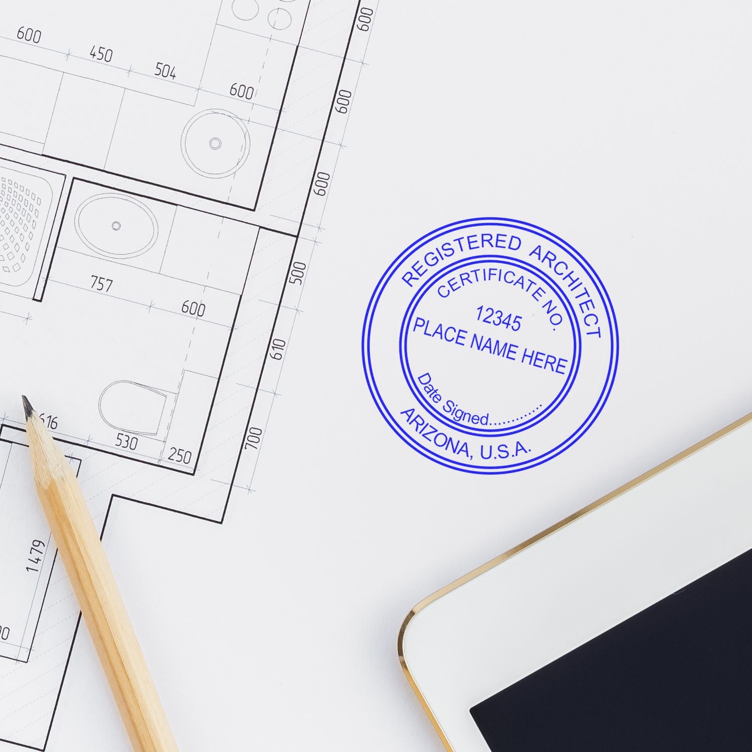 Self Inking Arizona Architect Stamp on architectural blueprint with pencil and tablet nearby.