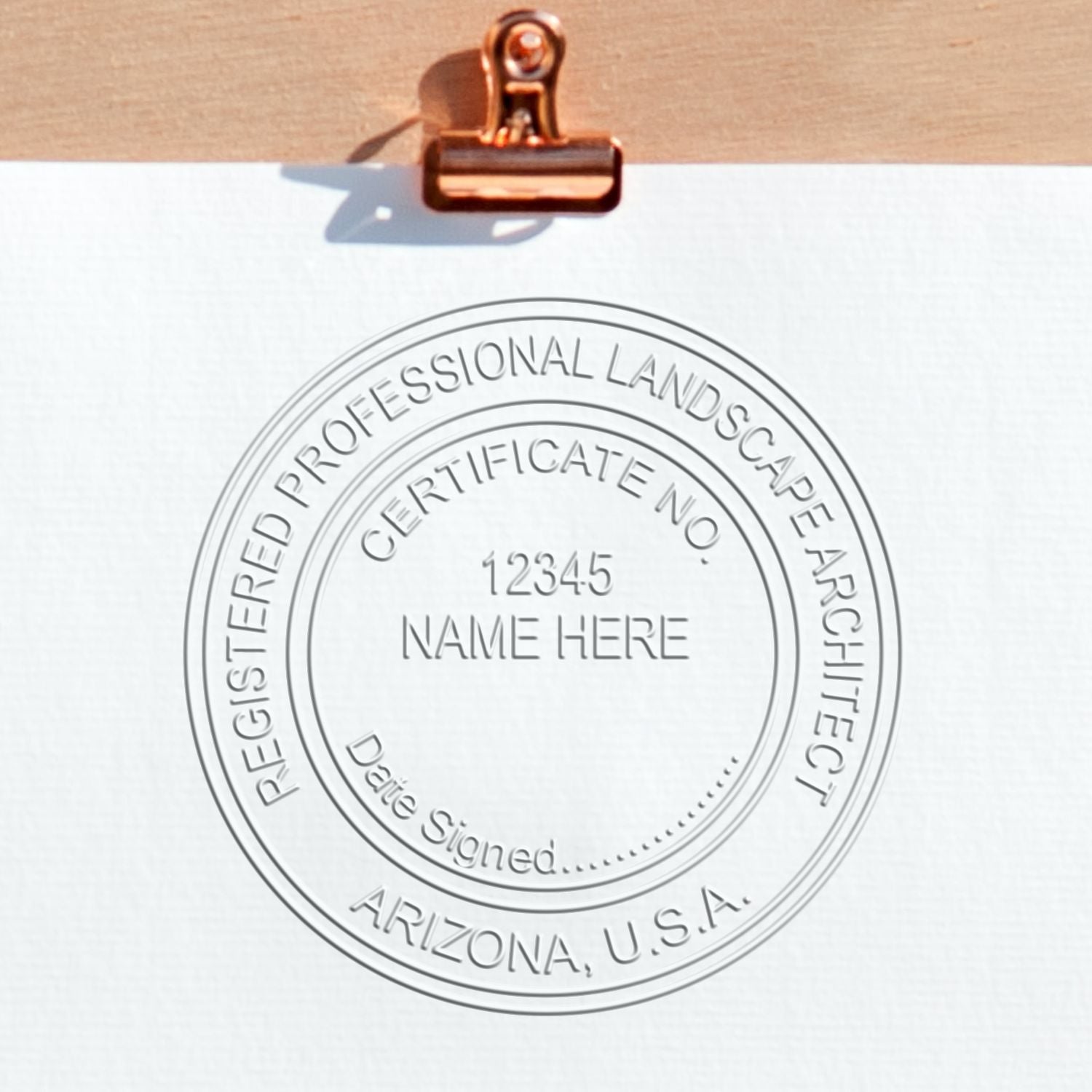 A stamped impression of the State of Arizona Extended Long Reach Landscape Architect Seal Embosser in this stylish lifestyle photo, setting the tone for a unique and personalized product.