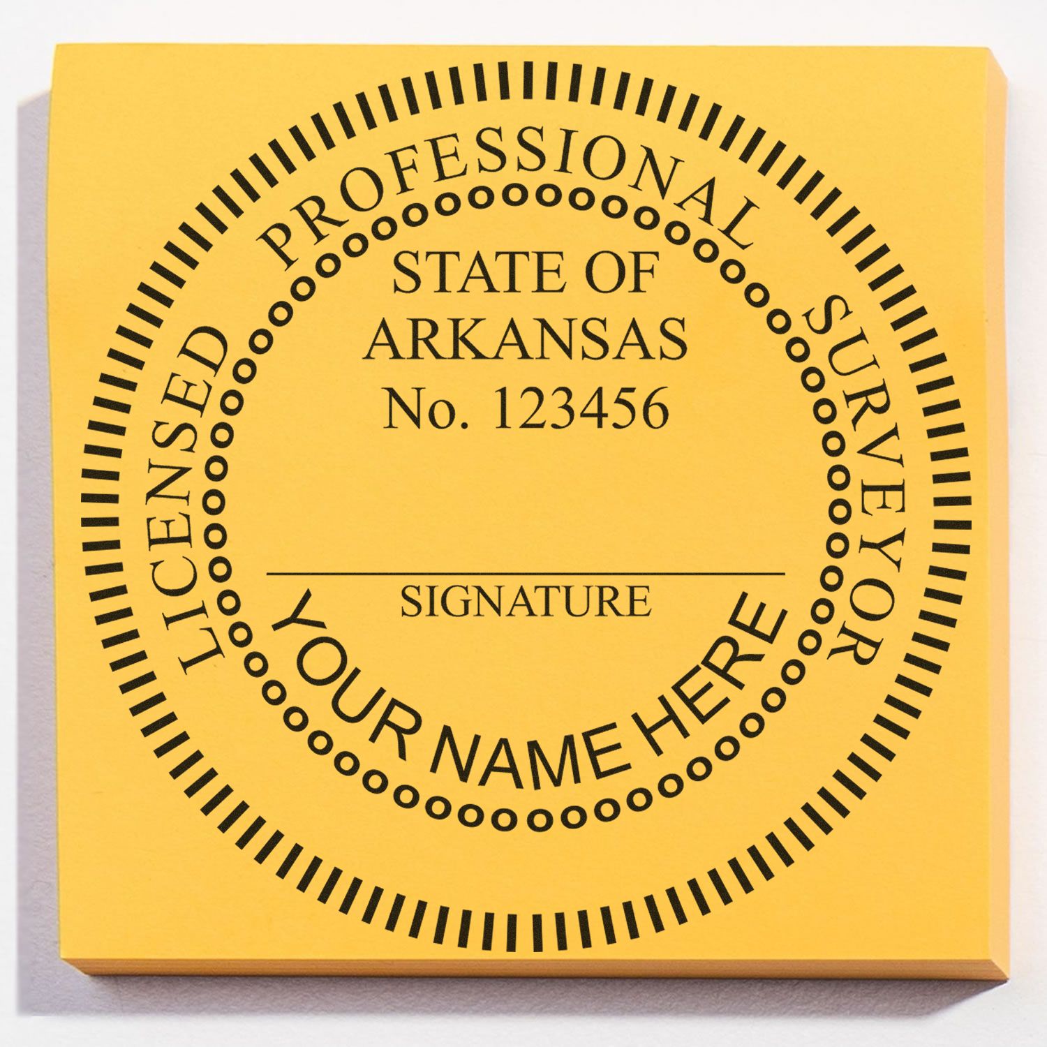 Self Inking Arkansas Land Surveyor Stamp with customizable name, signature, and license number on a yellow background.