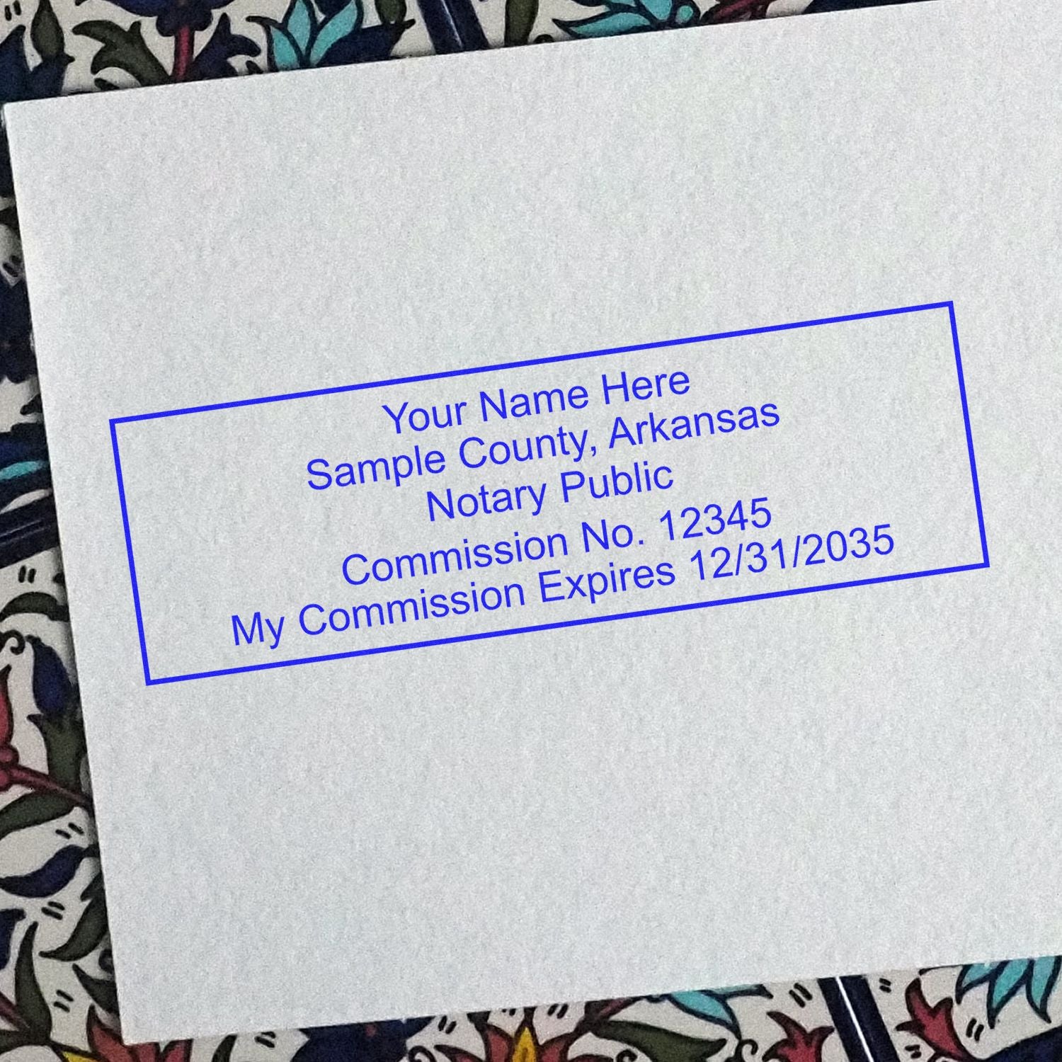This paper is stamped with a sample imprint of the Slim Pre-Inked Rectangular Notary Stamp for Arkansas, signifying its quality and reliability.