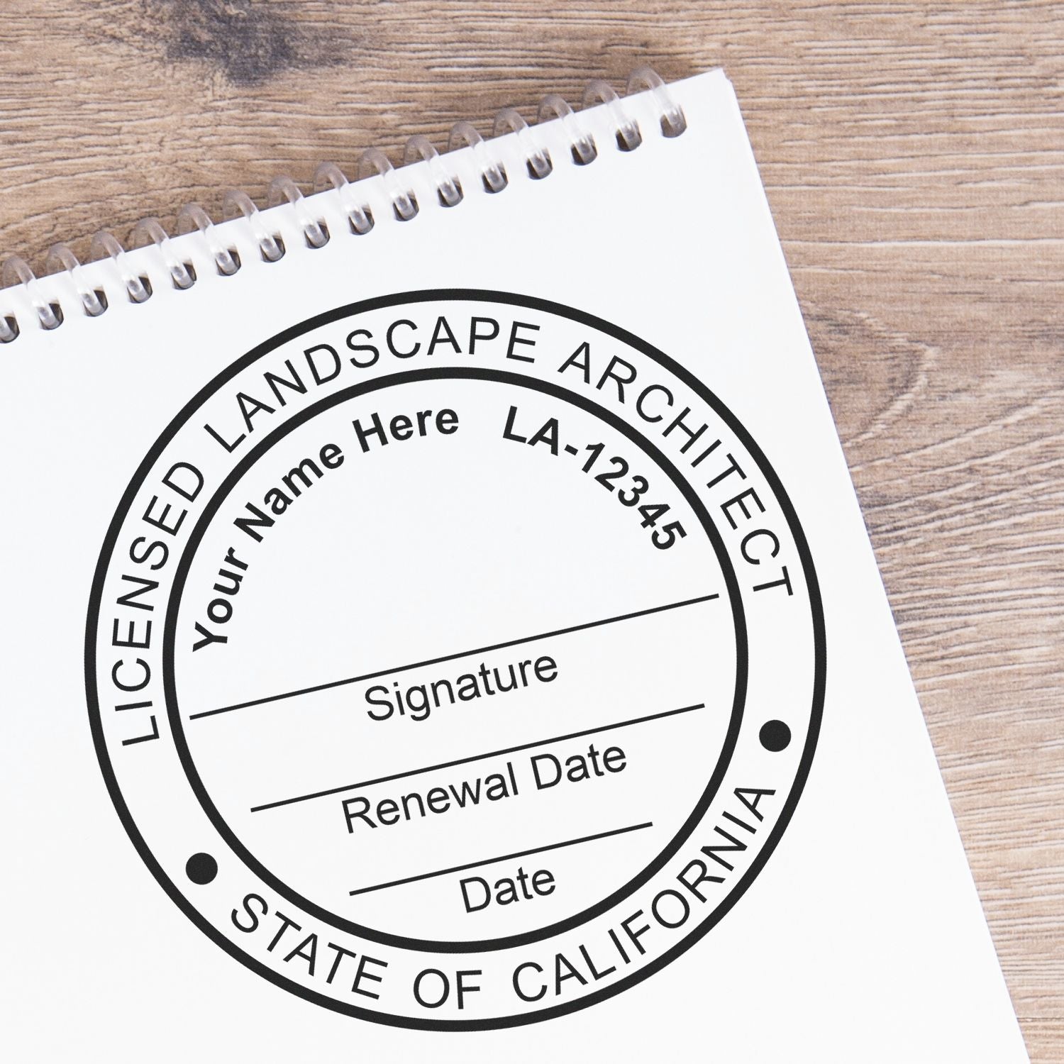 A lifestyle photo showing a stamped image of the Digital California Landscape Architect Stamp on a piece of paper