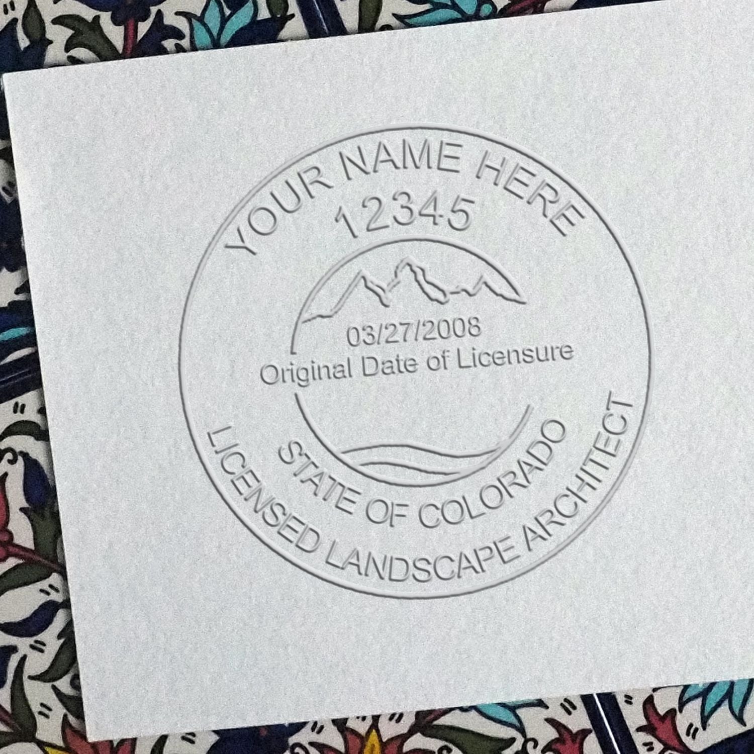 A stamped impression of the State of Colorado Handheld Landscape Architect Seal in this stylish lifestyle photo, setting the tone for a unique and personalized product.