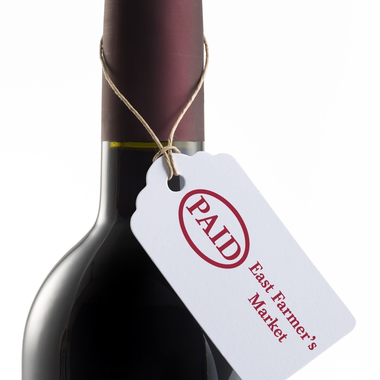 A wine bottle with a tag stamped PAID and East Farmer's Market using a 2 Line Custom Rubber Stamp with Wood Handle.