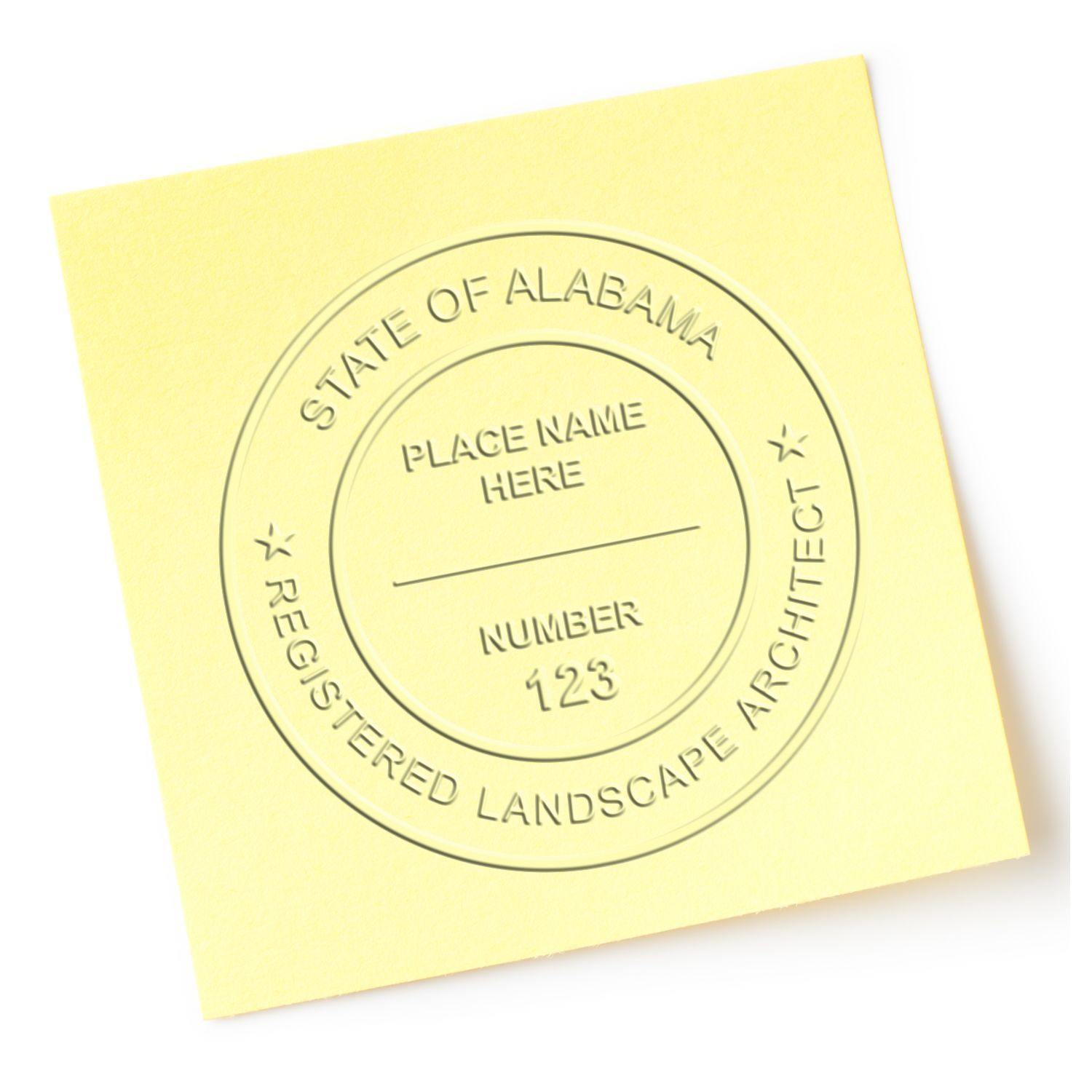 A yellow paper embossed with a State of Alabama Registered Landscape Architect seal using the Landscape Architect Black Gift Seal Embosser.