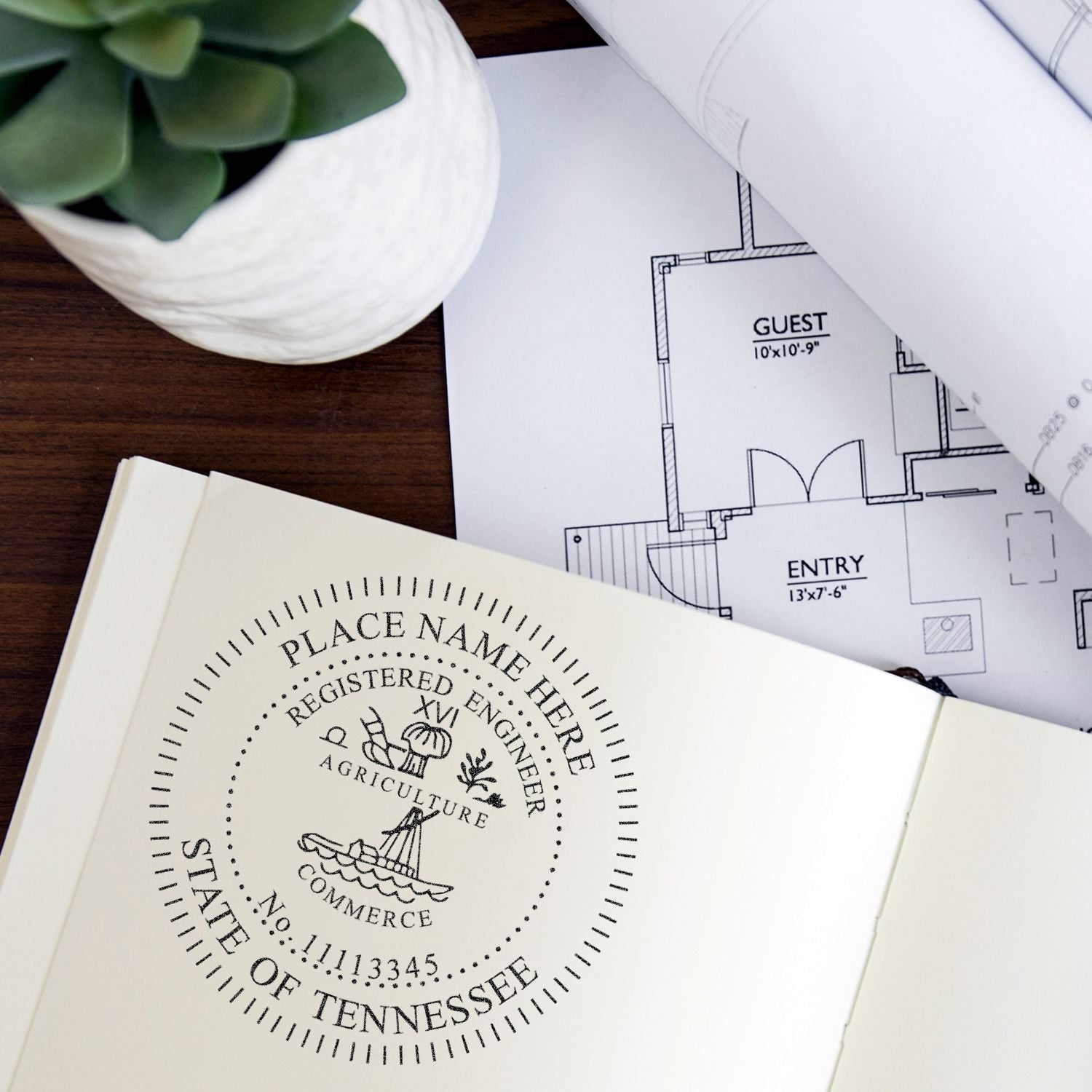 Professional Engineer Slim Pre-Inked Stamp of Seal used on a document, with architectural plans and a potted plant in the background.