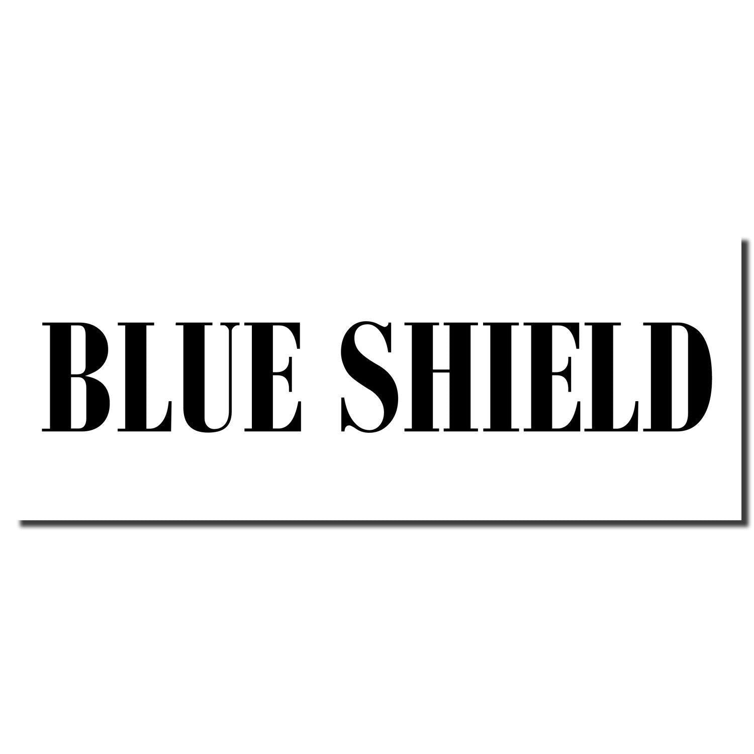 Black imprint of the Blue Shield Rubber Stamp on a white background, featuring bold, uppercase text reading 'BLUE SHIELD'.