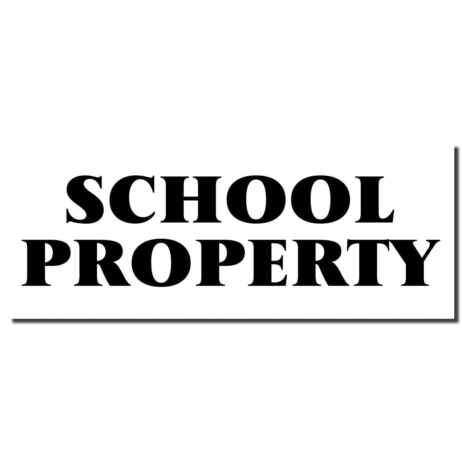 Black rubber stamp imprint with bold text reading 'SCHOOL PROPERTY' on a white background.