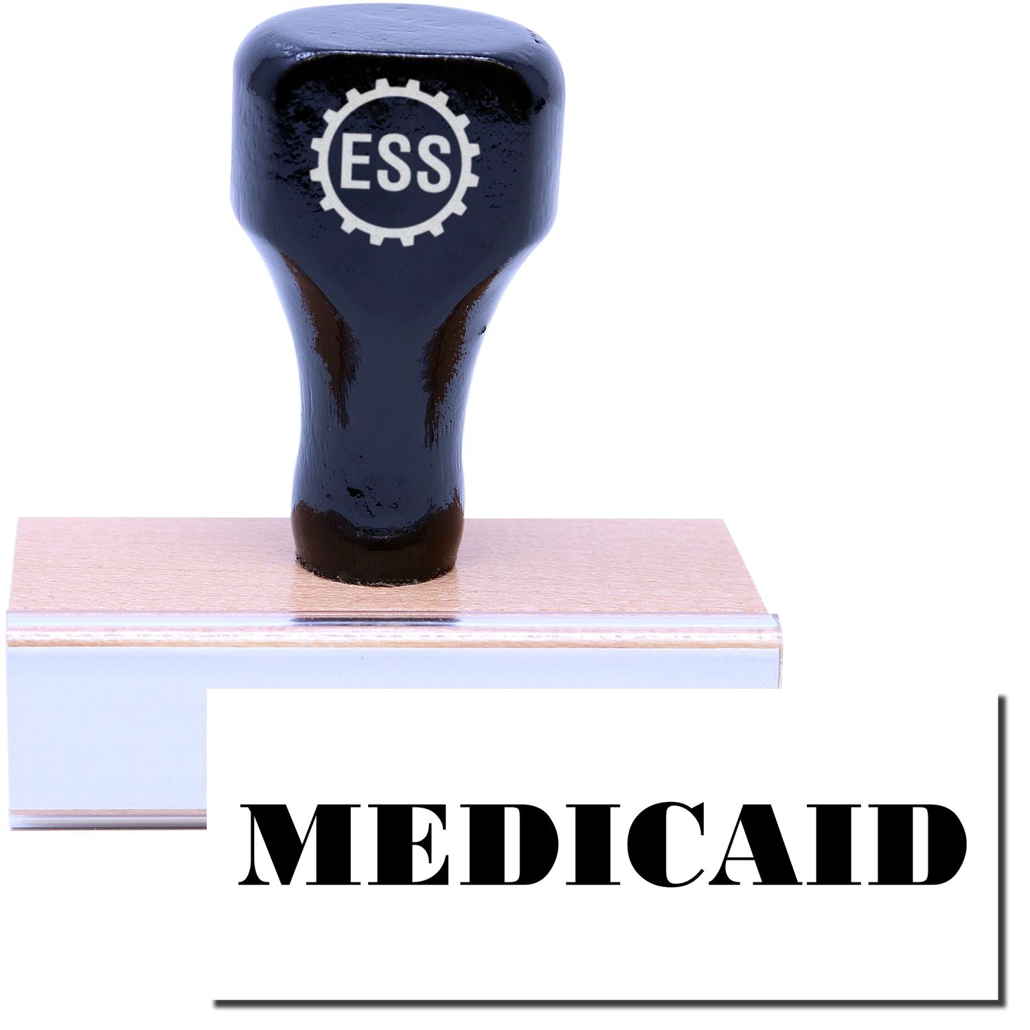 A stock office rubber stamp with a stamped image showing how the text MEDICAID in a large font is displayed after stamping.