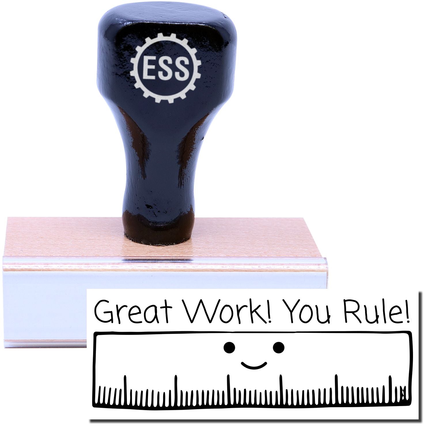 A stock office rubber stamp with a stamped image showing how the text Great Work! You Rule! with an image of a ruler with a smiling face is displayed after stamping.