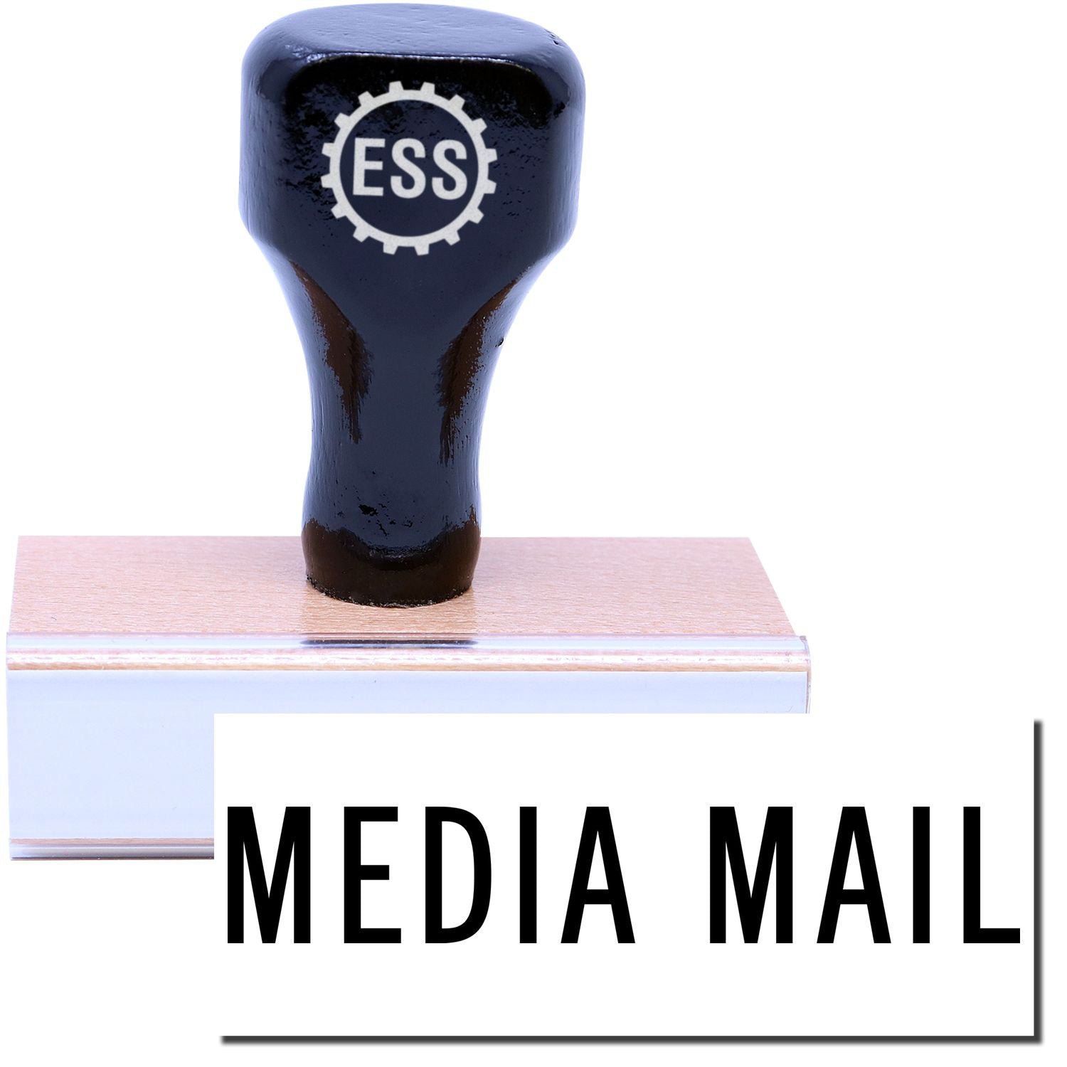 A stock office rubber stamp with a stamped image showing how the text MEDIA MAIL in a large font is displayed after stamping.