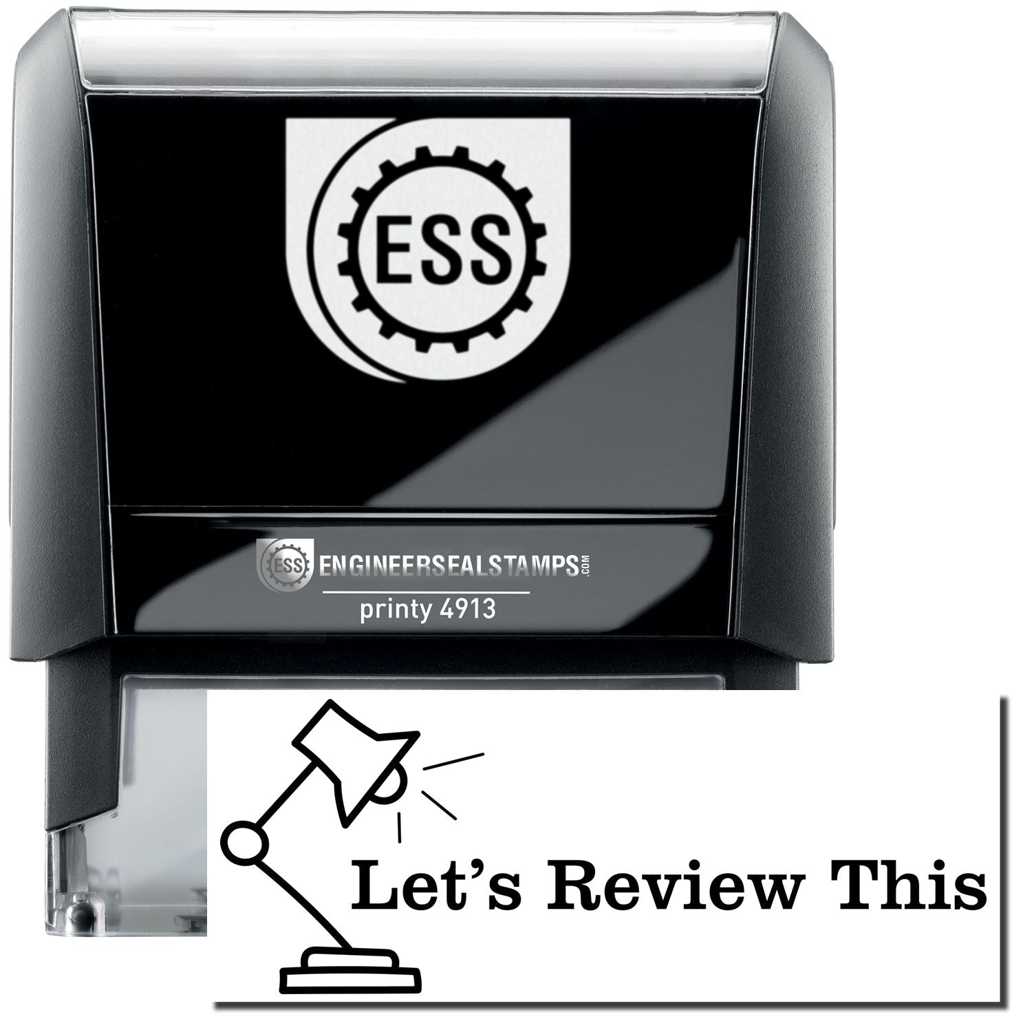 A self-inking stamp with a stamped image showing how the text Let's Review This in a large font with a Lamp is displayed by it after stamping.